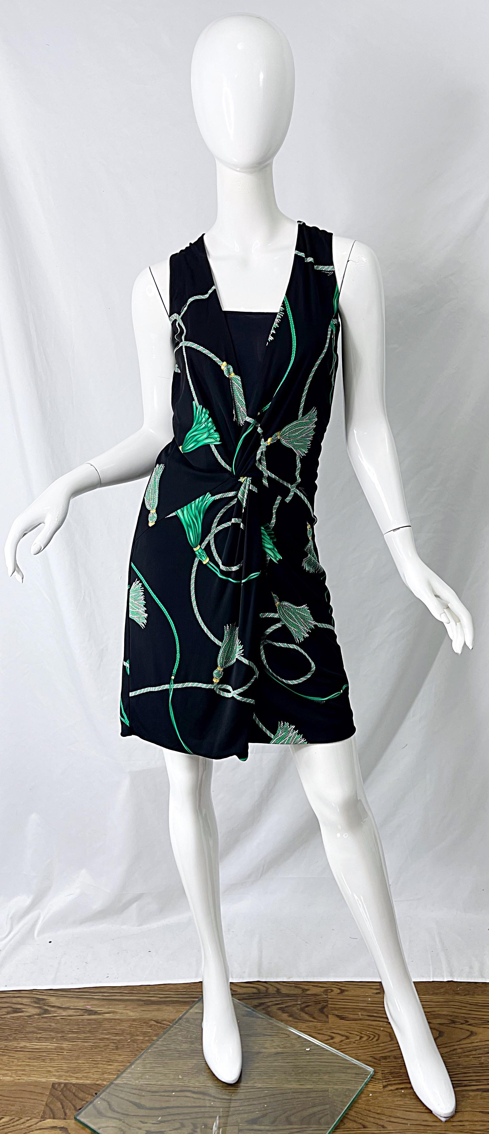 Chic GUCCI Resort 2007 black and green logo tassel print faux wrap dress ! Features a tailored bodice with ruching detail at center waist. Hidden zipper up the back with hook-and-eye closure. The perfect alternative to the little black dress.