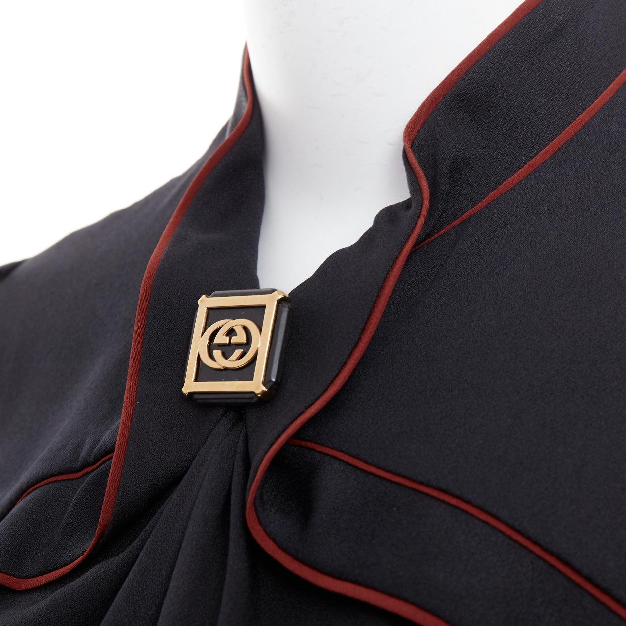 GUCCI 2007 Vintage black silk gold GG logo charm red piped top IT38 XS
Reference: WECN/A00019
Brand: Gucci
Collection: 2007
Material: Silk
Color: Black, Red
Pattern: Solid
Closure: Hook & Bar
Extra Details: GG logo button at neckline.
Made in: