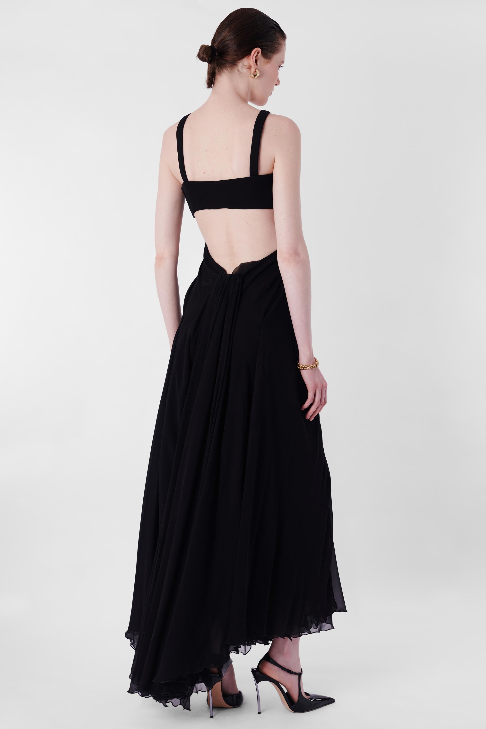 Nordic Poetry is excited to present this incredible Gucci 2008 Black Silk Cutout Maxi Dress. Features cross front straps, Side body hooks, twisted skirt detail and maxi length. In excellent vintage condition. Authenticity guaranteed.

Label size: 40
