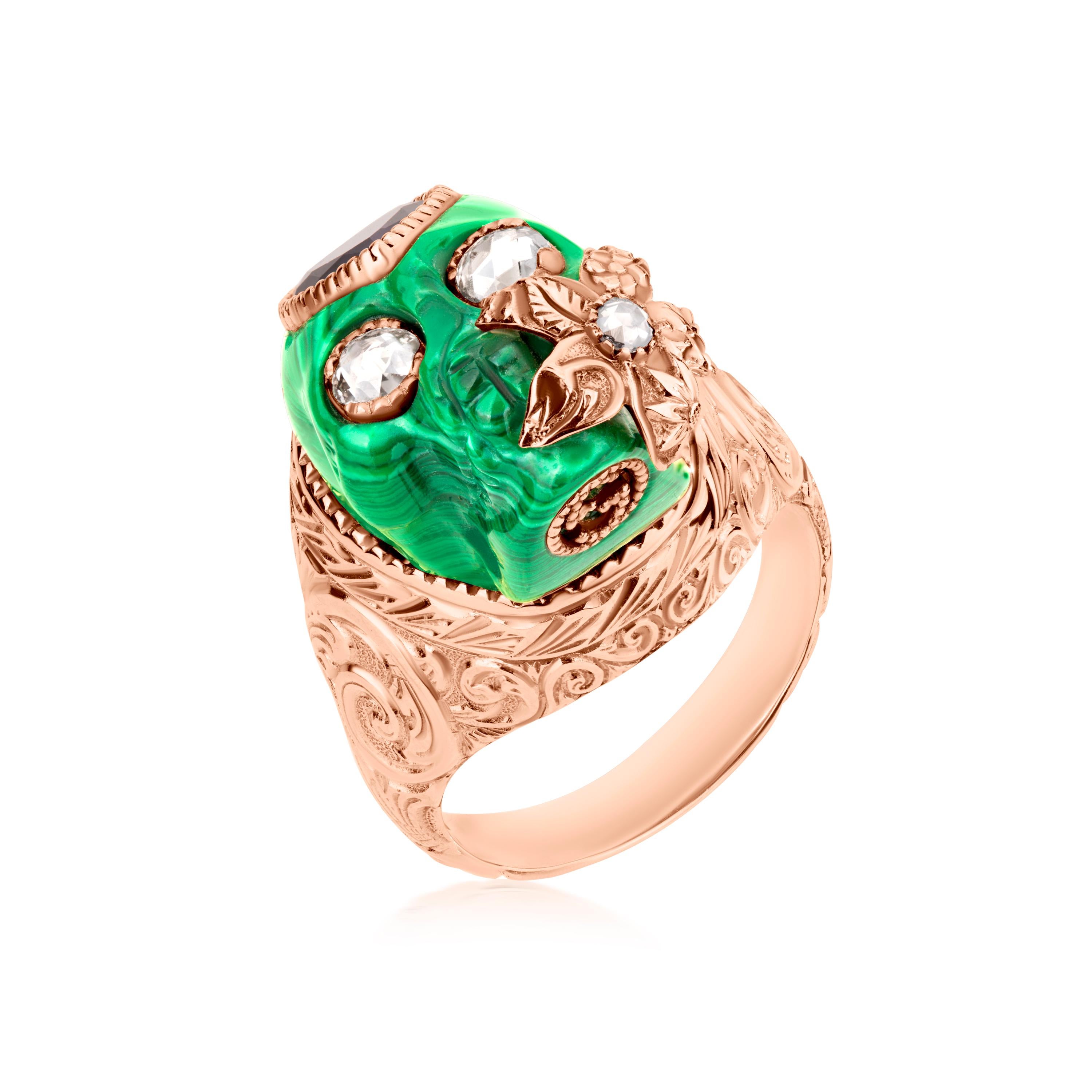 This Gucci skull ring with heart and rose cut diamond eyes spread over the vibrant green of malachite is a showstopper. Intricate carvings over the 18k gold body make it undoubtedly a fashion statement and one of a kind piece. 
Please follow the