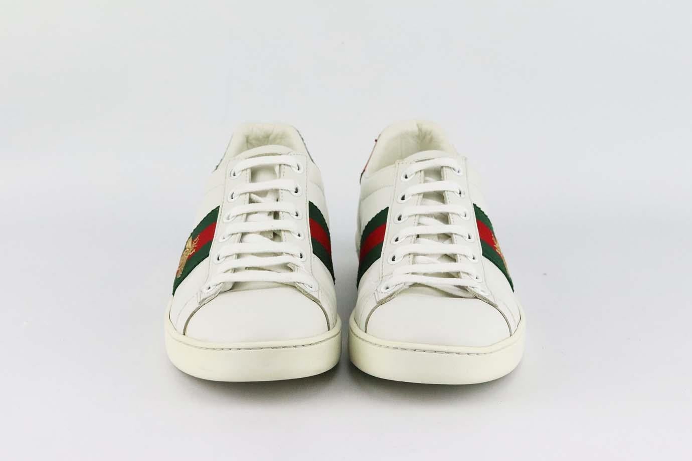 These 'Ace' sneakers by Gucci are a cool, sporty take on the now iconic style, made in Italy from pristine white leather, they have the instantly recognizable green and red webbing that's embroidered with a the brands iconic gold bee. Rubber sole