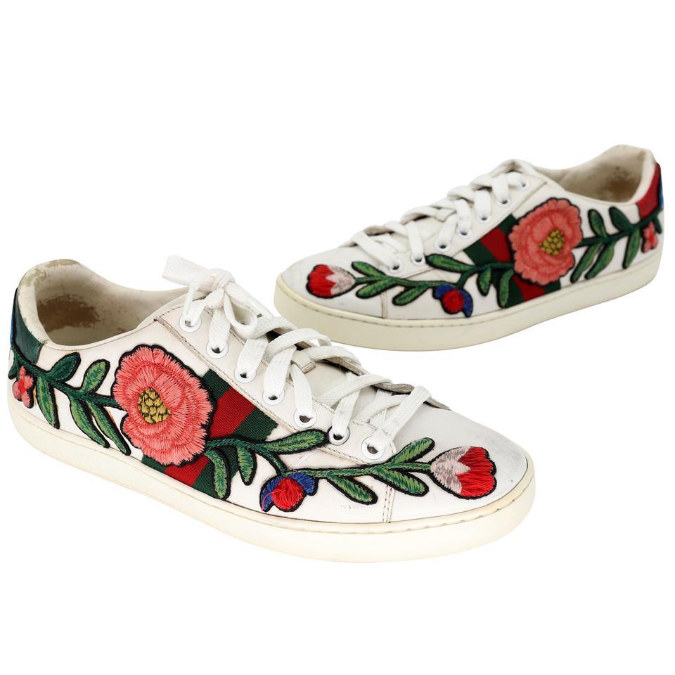 These stylish sneakers are crafted of soft leather and embellished with the iconic Gucci green and red web canvas with multicolored embroidered flowers at the sides and metallic red and green snakeskin at the heels. These are fabulous eye-catching