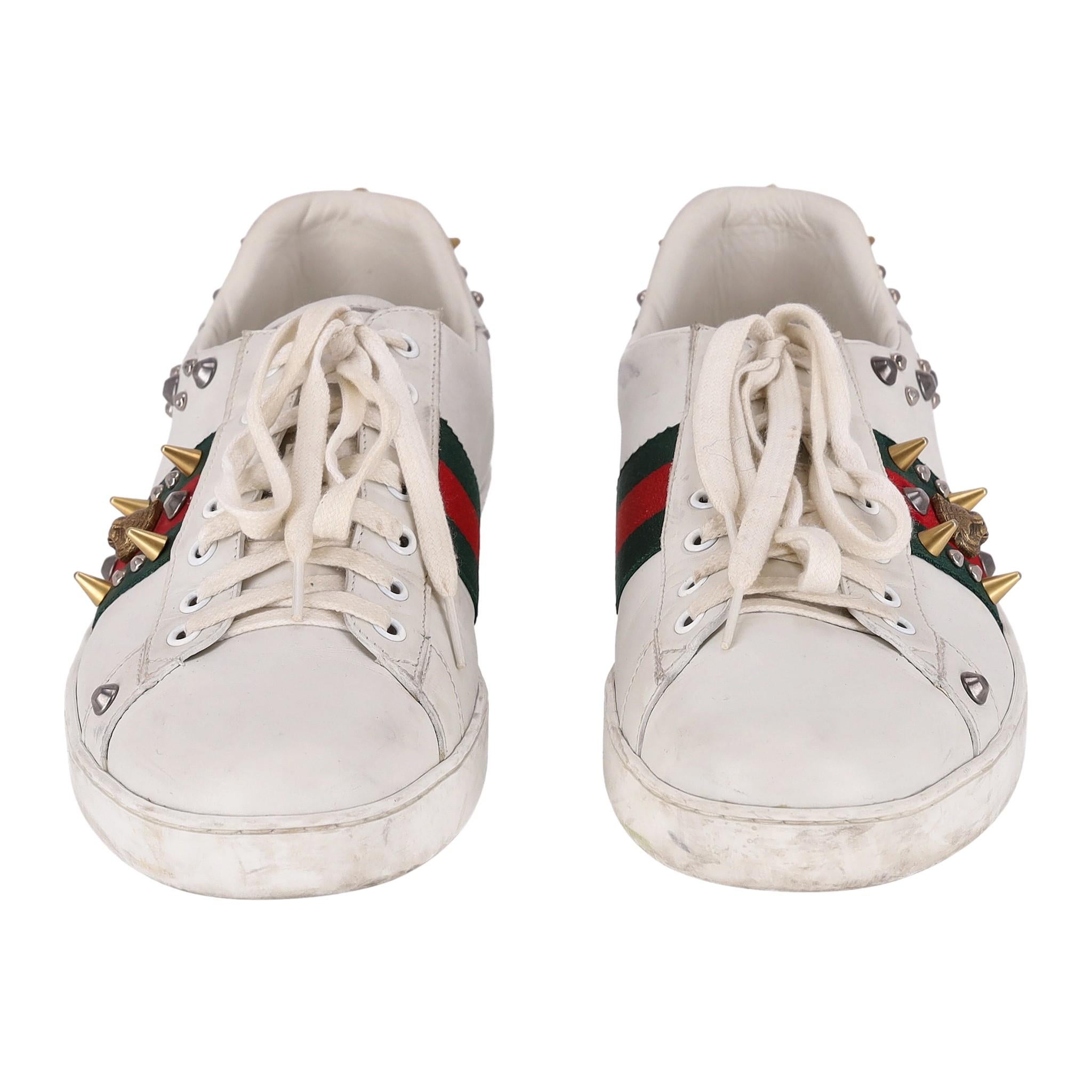 Gucci Ace Punk Web Studded Leather Sneakers

White sneakers crafted in calfskin leather and designed with signature red and green web stripe to the side with tiger head embellishment and decorative silver and gold studs.

Detailed with gold spike