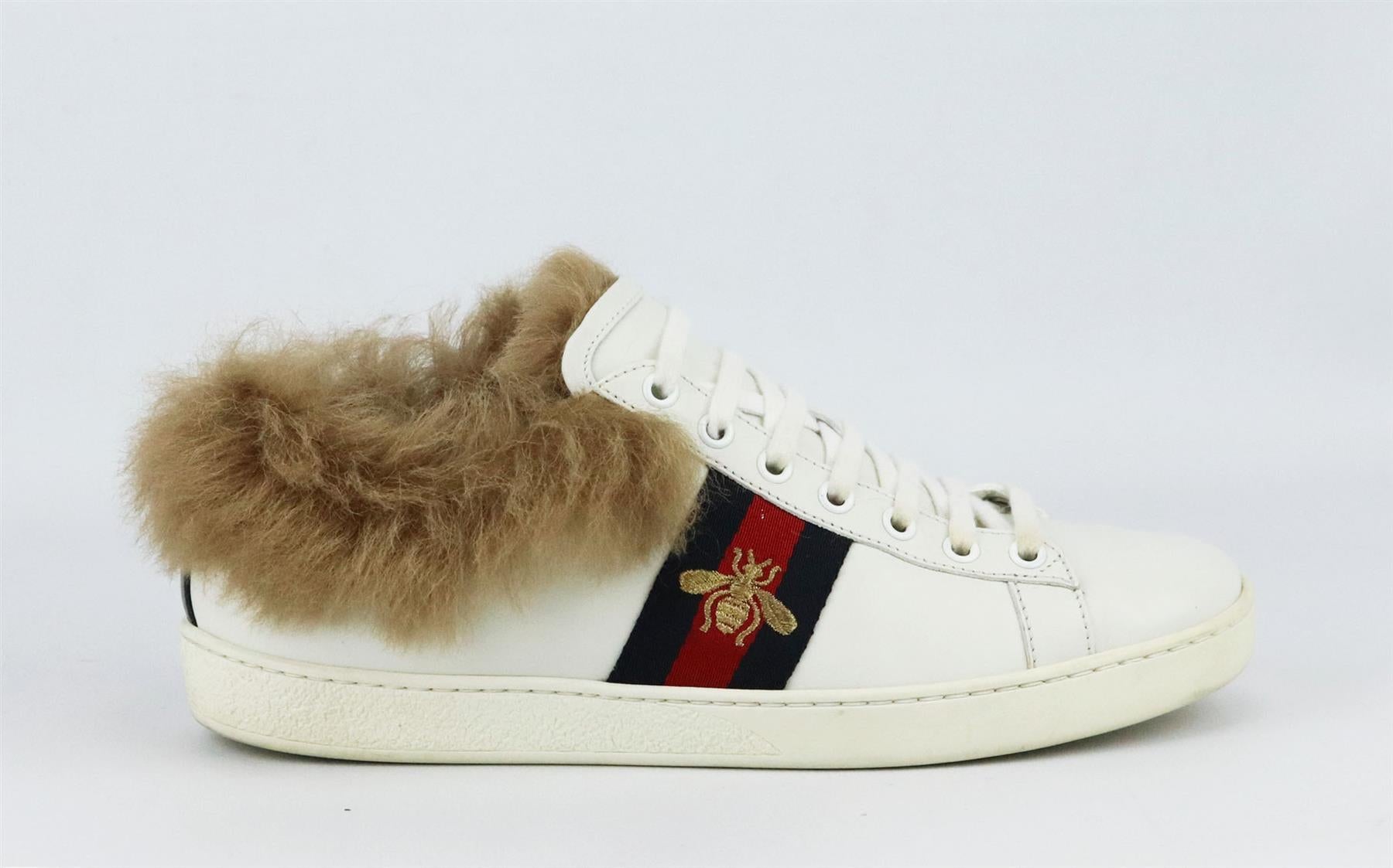 These 'Ace' sneakers by Gucci are a cool, sporty take on the now iconic style, made in Italy from pristine white leather, they have the instantly recognizable navy and red webbing that's embroidered with a gold bee while the shearling lining keep