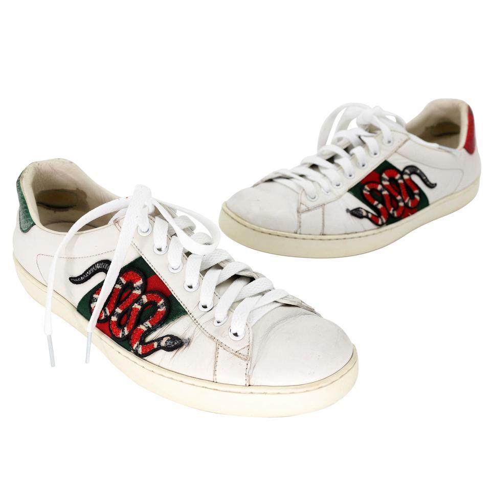 These stylish sneakers are crafted of soft leather and embellished with the iconic Gucci green and red web canvas with multicolored embroidered snake at the sides and metallic red and green snakeskin at the heels. These are fabulous eye-catching