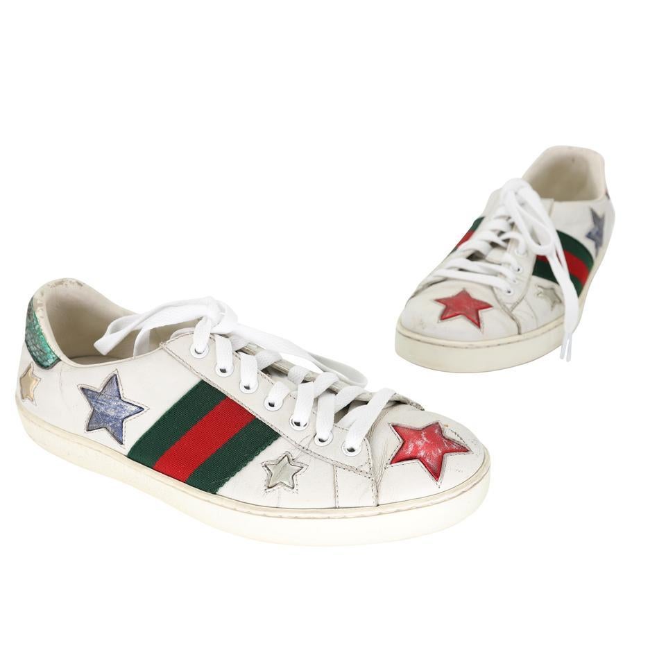 These stylish sneakers are crafted of soft leather and embellished with the iconic Gucci green and red web canvas with multicolored embroidered star detail at the sides and metallic red and green snakeskin at the heels. These are fabulous