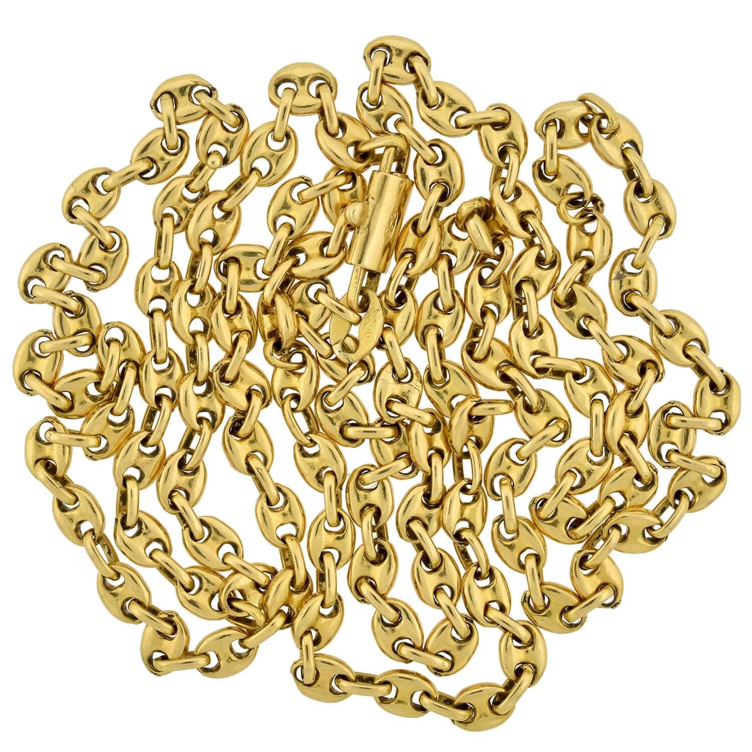 An absolutely fabulous signed Gucci anchor link chain from the 1970s era! Crafted in solid 18kt yellow gold, the necklace is comprised of small anchor links alternating with oval-shaped connectors to form a long, flowing chain. The necklace fastens