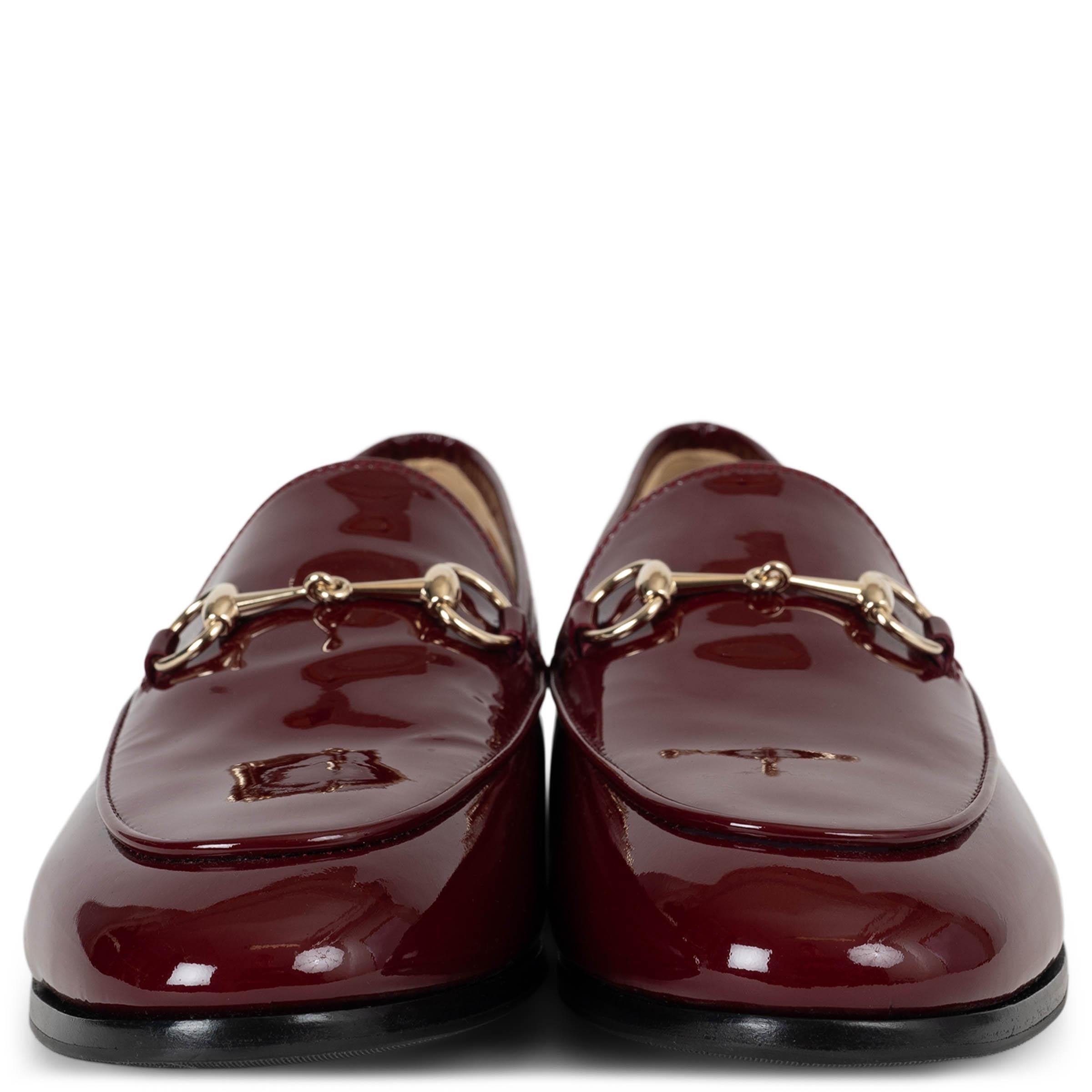 These 100% authentic Gucci Jordaan loafers in Ancora (burgundy) patent leather exude timeless elegance and refined style. Featuring the signature light-gold-tone horsebit on the front, they add a touch of classic Gucci heritage to the sleek, modern