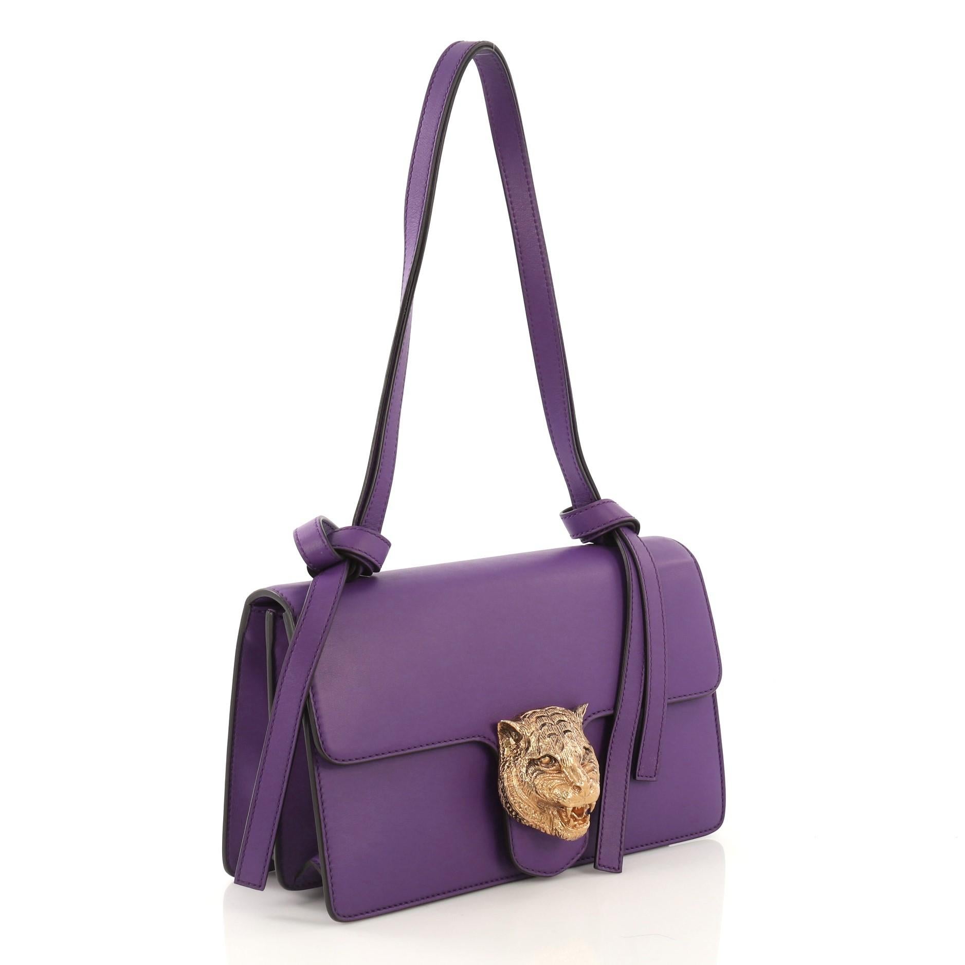This Gucci Animalier Flap Shoulder Bag Leather Medium, crafted from purple leather, features adjustable leather strap, tiger head detail on its flap, and aged gold-tone hardware. Its hidden snap closure open to a purple and neutral printed fabric