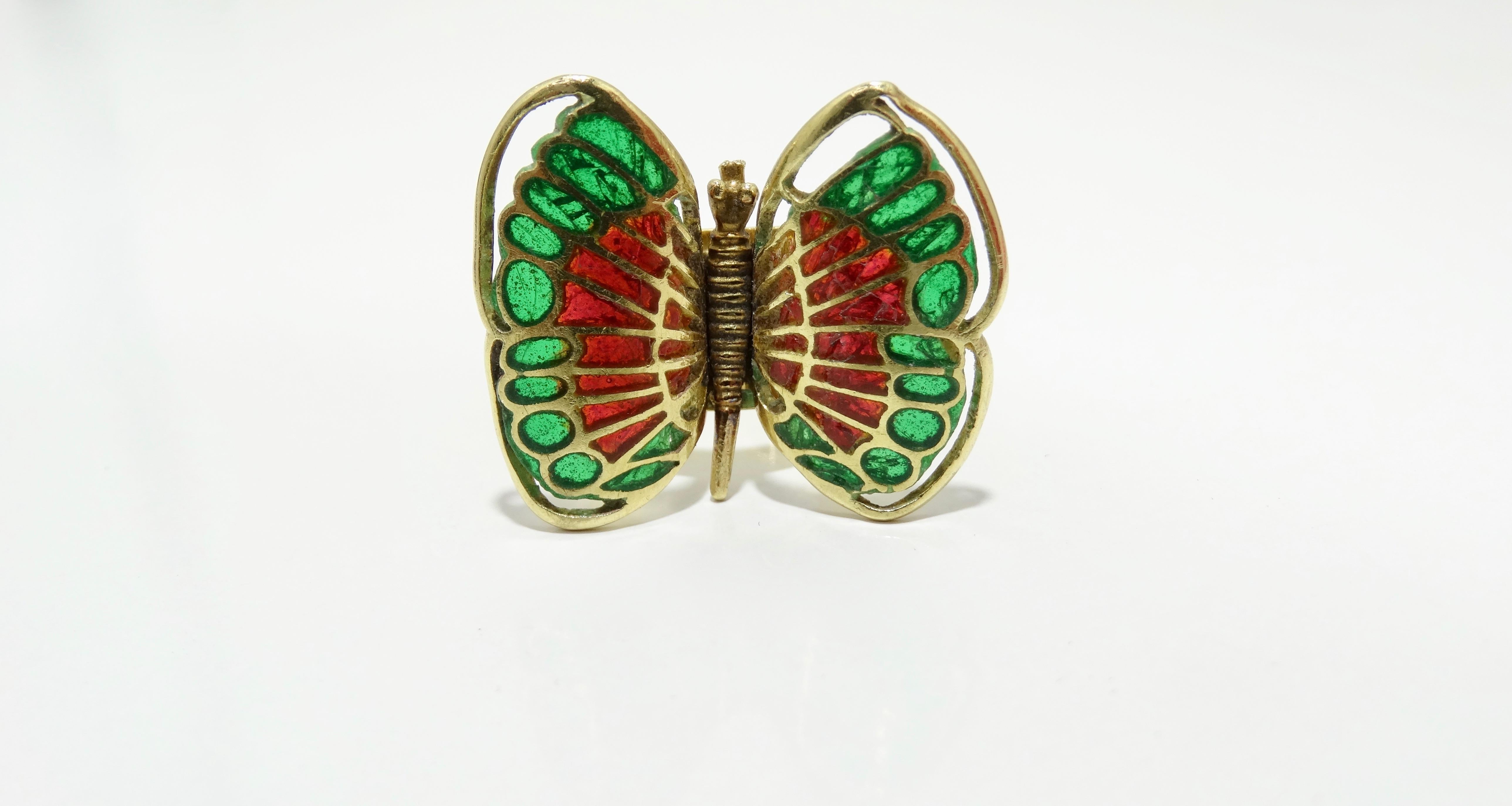This ring is sure to give you butterflies! This rare custom made antique Gucci ring is crafted from 18k gold and features a red and green glassed filled butterfly. Ring's band is adjustable and is stamped Gucci, Italy, 18k. Total weight is 11.15g. A