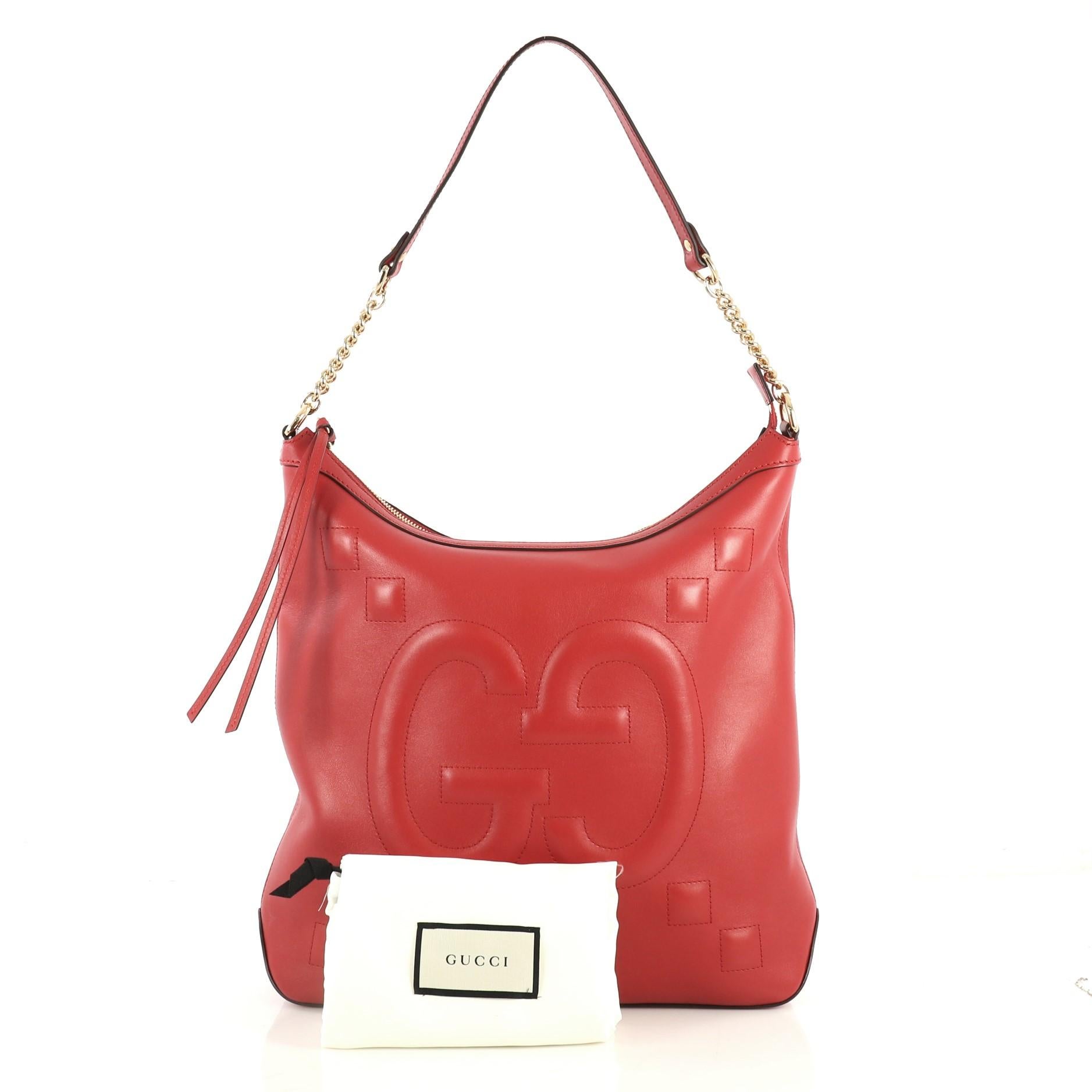 This Gucci Apollo Shoulder Bag GucciGhost Embossed Leather Large, crafted in red embossed leather, features chain link strap with leather and gold-tone hardware. Its zip closure opens to a neutral microfiber interior with zip and slip pockets.