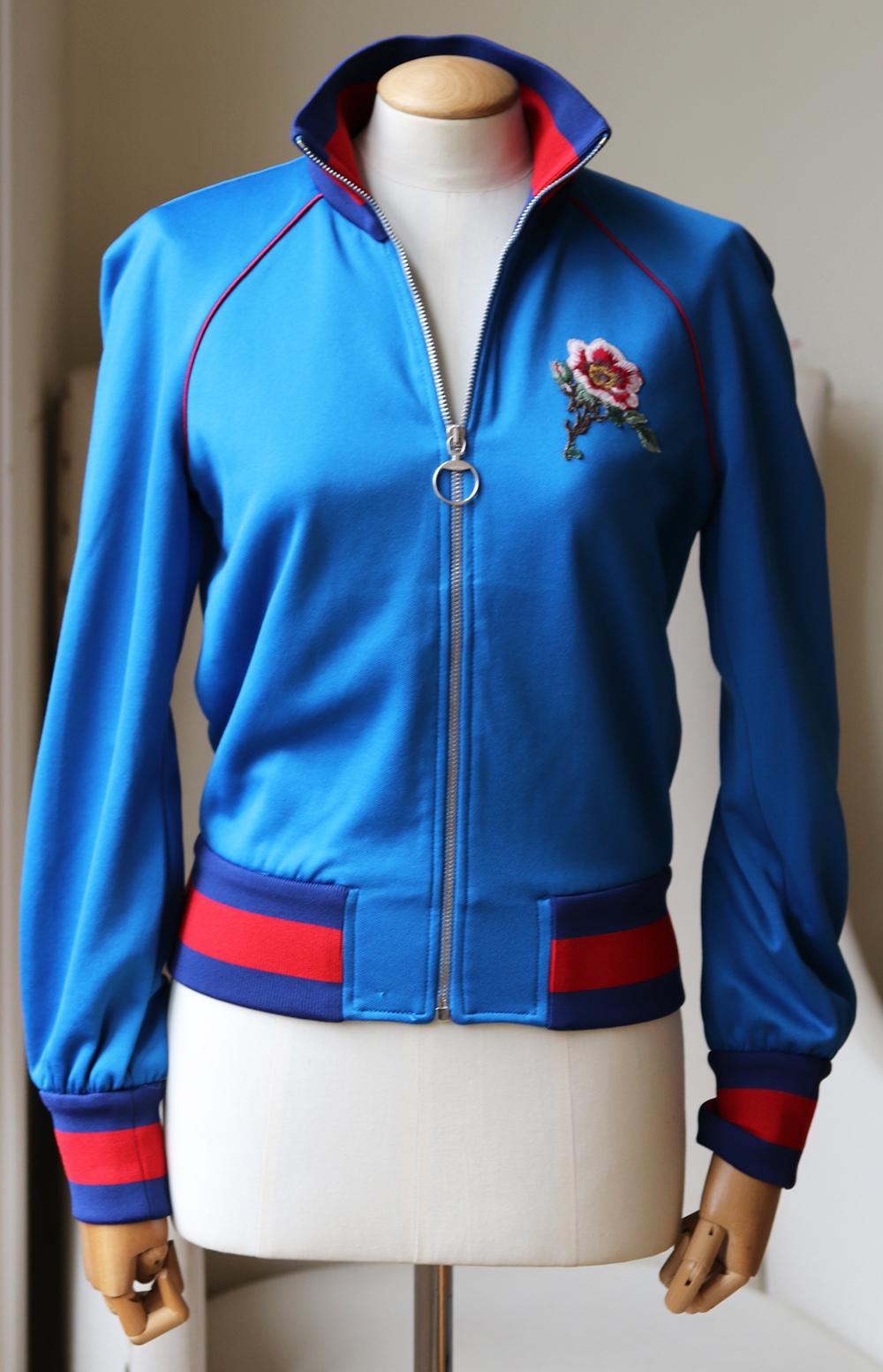 Cut from lustrous blue satin-jersey, this bomber jacket has the house's iconic web trims and is appliquéd with a roaring tiger and flower patches.
Blue satin-jersey.
Zip fastening along front. 
55% Polyester, 45% cotton; trim: 88% polyester, 12%