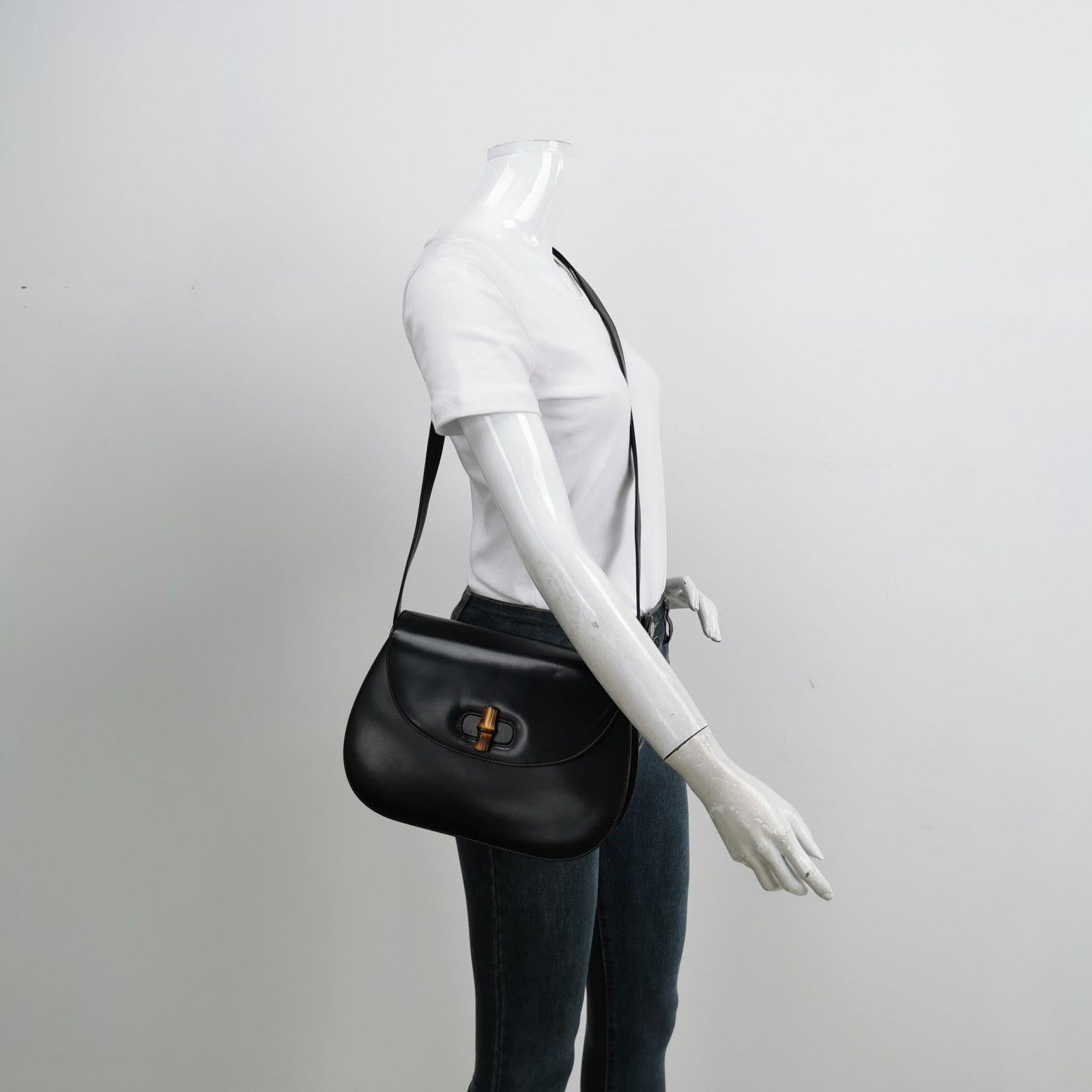 Gucci Bamboo 1947 Black Leather Medium Crossbody Bag These are professional photos of the actual bag offered by Luxbags. This Gucci crossbody bag has the signature oval design with the bamboo turn lock. Instead of the top bamboo handle, it comes