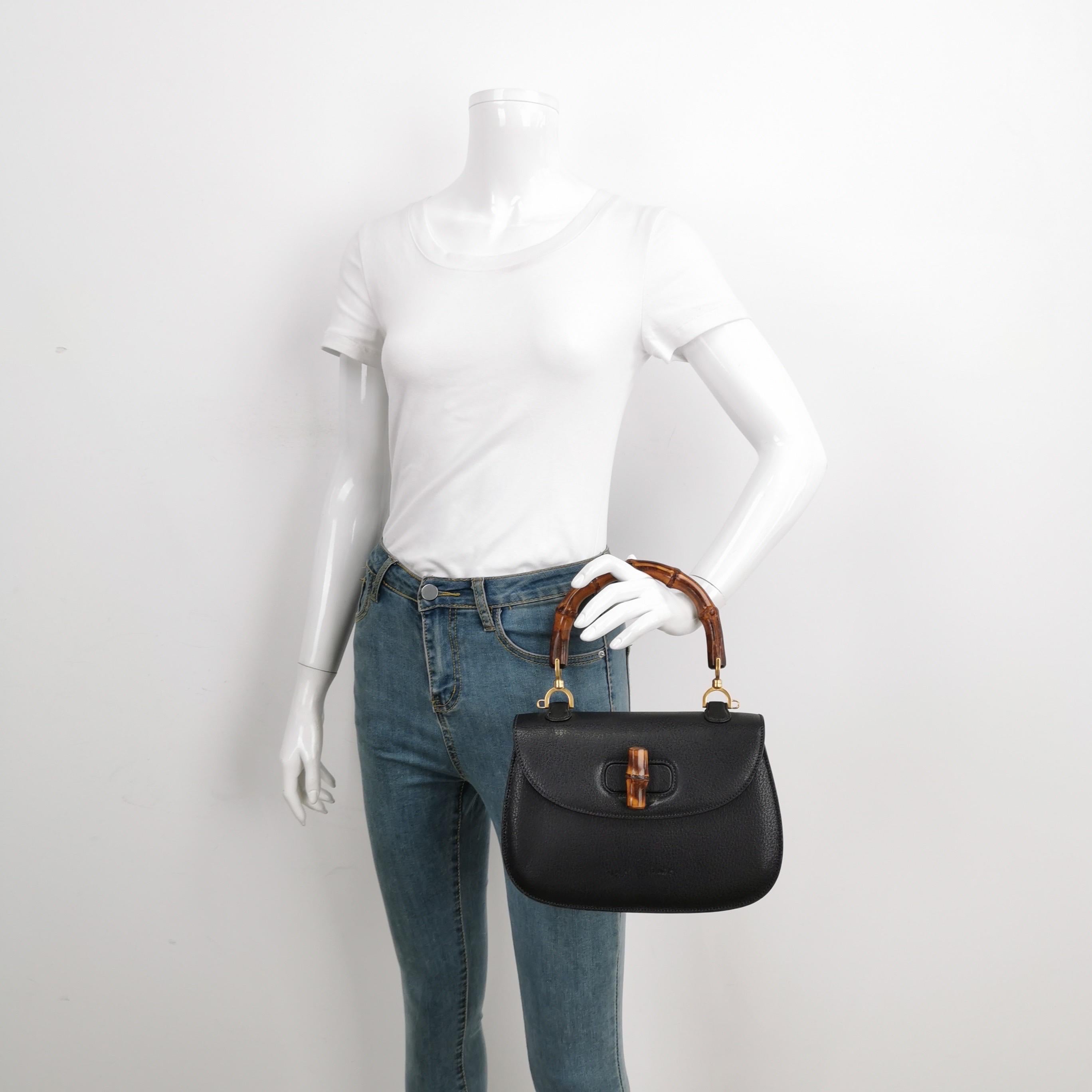Gucci Bamboo 1947 Top Handle Bag Leather Small Black
 These are professional photos of the actual bag offered
 This Gucci crossbody bag has the signature oval design with the bamboo turn lock.
 CONDITION: EXCELLENT
 Light rubbing around the corners,