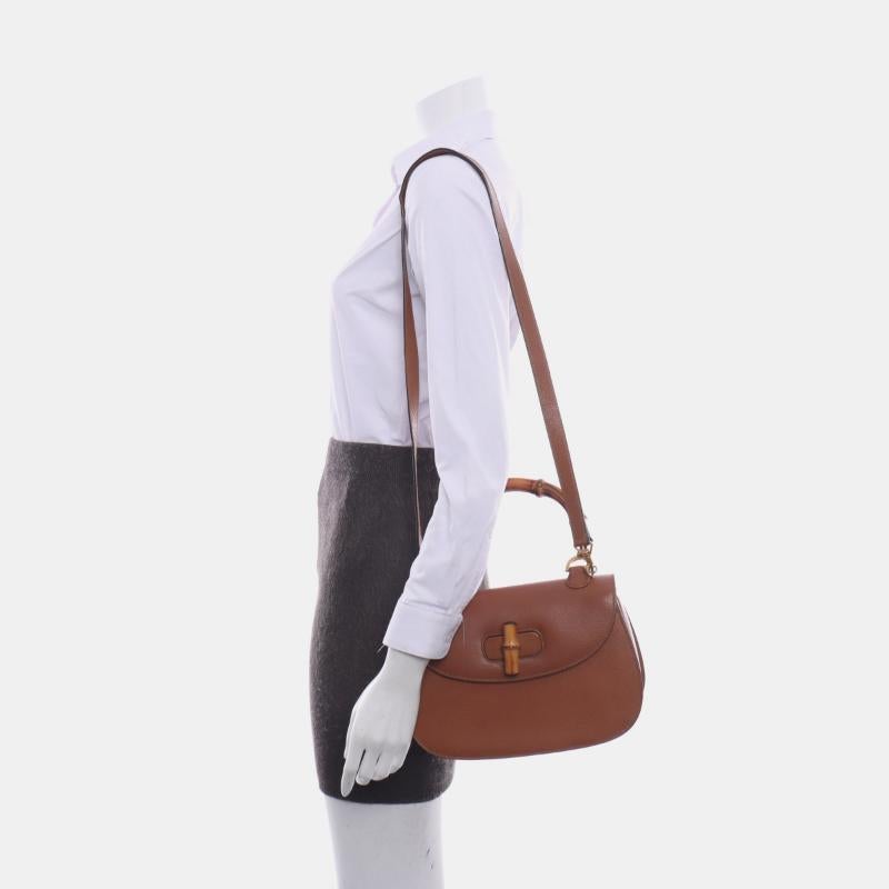 Gucci Bamboo 1947 Top Handle Bag Leather Medium Tan Brown
These are professional photos of the actual bag.
  This Gucci crossbody bag has the signature oval design with the bamboo turn lock.
  CONDITION: EXCELLENT
  Light rubbing around the corners,