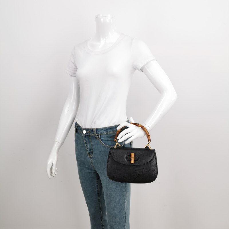 Gucci Bamboo 1947 Top Handle Bag Leather Small Black
 These are professional photos of the actual bag offered
 This Gucci crossbody bag has the signature oval design with the bamboo turn lock.
 CONDITION: EXCELLENT
 Light rubbing around the corners,