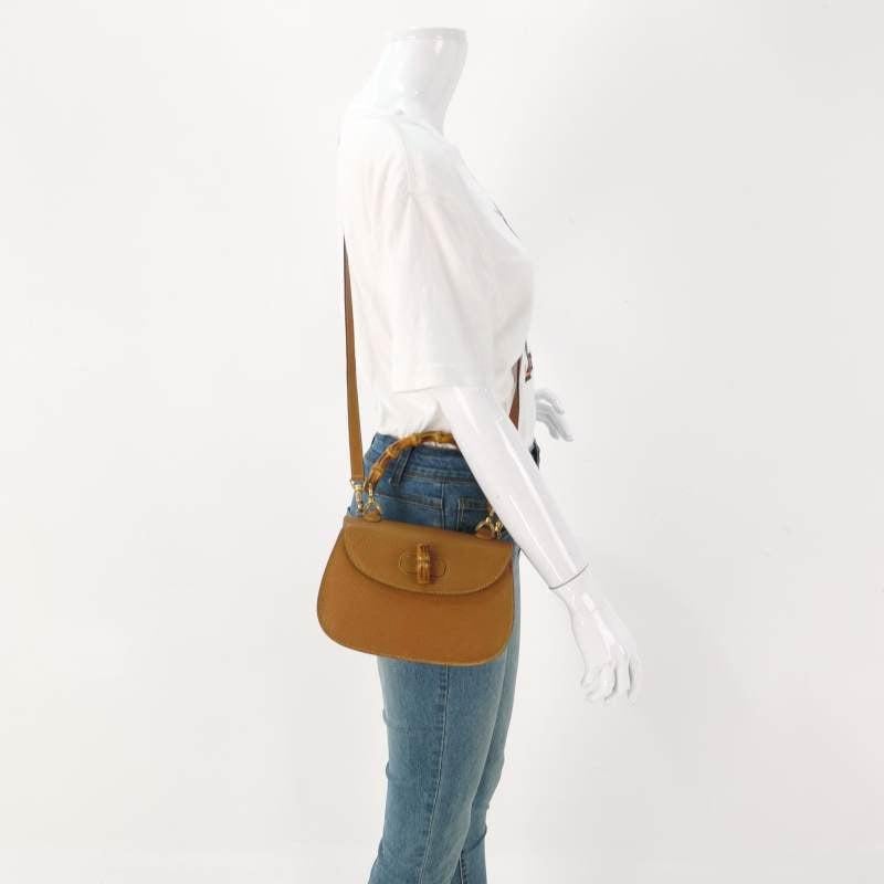 Gucci Bamboo 1947 Top Handle Bag Leather Small Camel with Strap
 These are professional photos of the actual bag offered
 This Gucci crossbody bag has the signature oval design with the bamboo turn lock.
 CONDITION: EXCELLENT
 Light rubbing around
