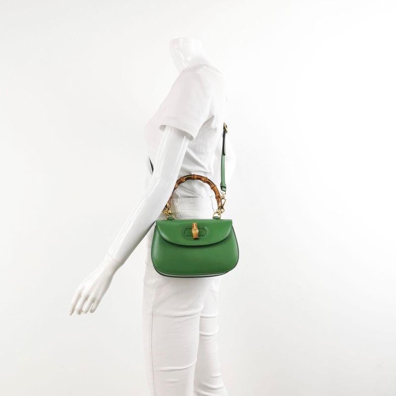 Gucci Bamboo 1947 Top Handle Bag Small Green Box Leather
 These are professional photos of the actual bag.
 This Gucci crossbody bag has the signature oval design with the bamboo turn lock.
 CONDITION: EXCELLENT
 Light rubbing around the corners.