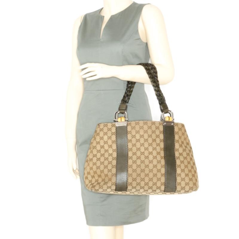 This large handbag from Gucci is a must have for the shopaholic in you. Made with beige guccissima canvas with olive green leather trim, this bag can organize all your belongings thanks to its multiple compartment interior. It features double hand