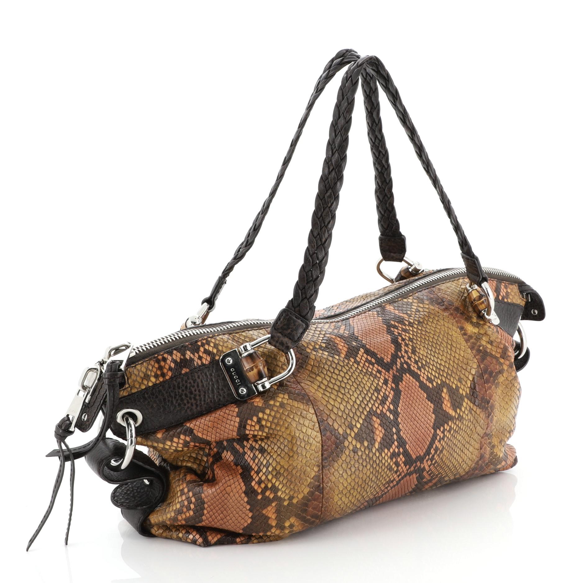 This Gucci Bamboo Bar Shoulder Bag Python Medium, crafted in genuine brown python skin, features dual braided leather handles and silver-tone hardware. Its two-way zip closure opens to a brown leather interior with side zip and slip