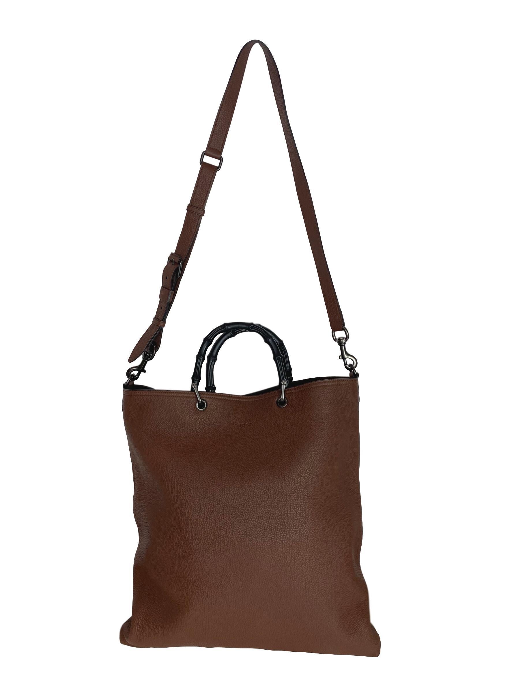 Gucci Bamboo Brown Large Shopper Tote with Strap, circa 2018. This large shopper tote comes in a rich brown pebble leathered material, double black painted bamboo handles and a detachable shoulder strap. This bag has a beautiful suede lined interior