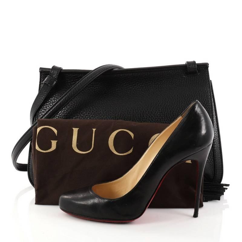 This authentic Gucci Bamboo Daily Flap Bag Leather is a simple yet elegant daily crossbody bag for on-the-go woman. Crafted in black leather, this easy-chic bag features frontal flap with bamboo tassel fringes, adjustable leather strap, subtle Gucci