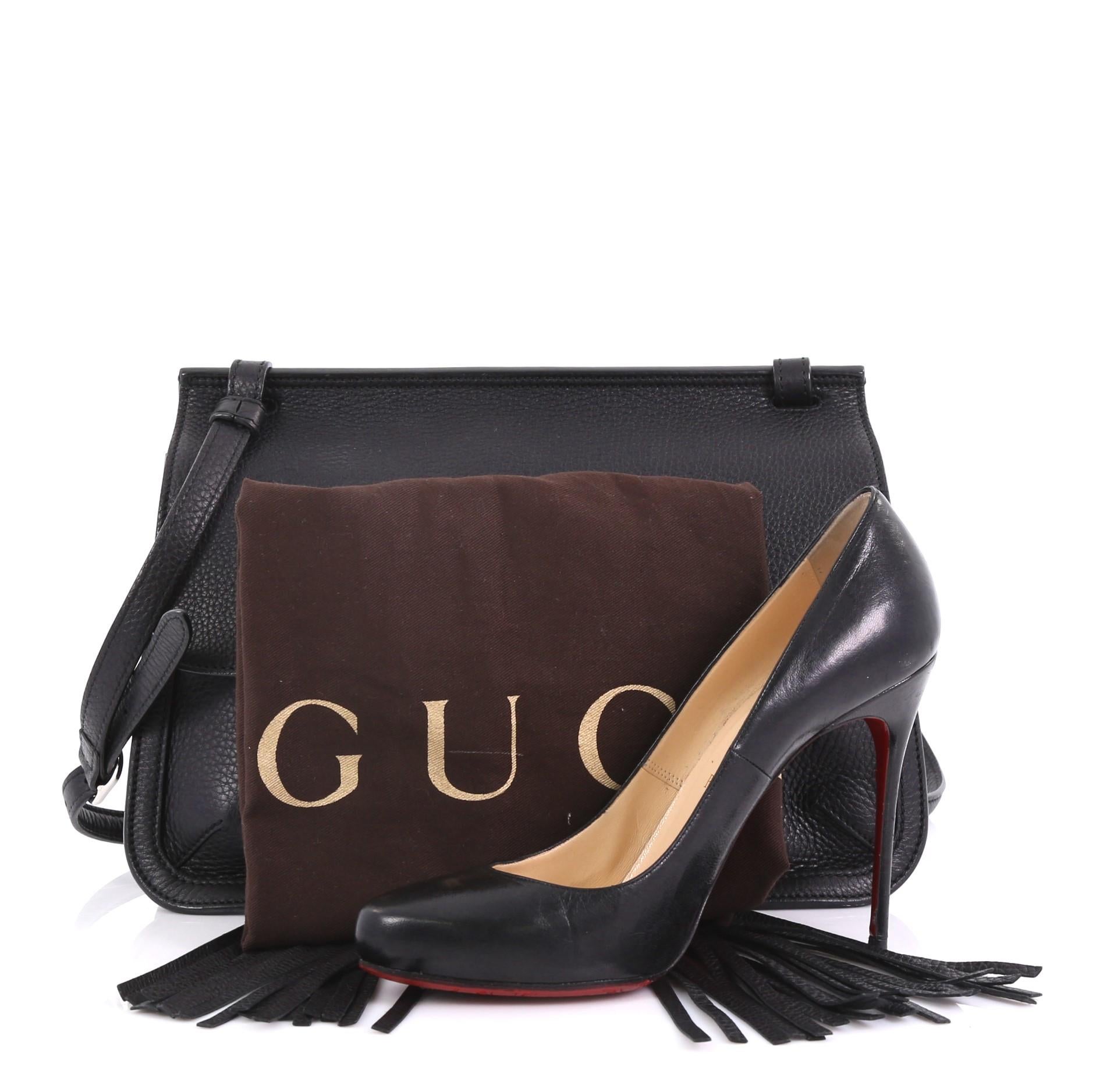 This Gucci Bamboo Daily Flap Bag Leather, crafted in black leather, features frontal flap with bamboo tassel fringe, adjustable leather strap, subtle Gucci logo, and silver-tone hardware. Its flap opens to a multicolor fabric interior with side zip