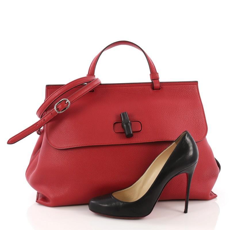 This Gucci Bamboo Daily Top Handle Bag Leather Large, crafted from red leather, features a flat top handle and silver-tone hardware. Its flap with bamboo turn-lock closure opens to a multicolor fabric interior with slip pockets. **Note: Shoe