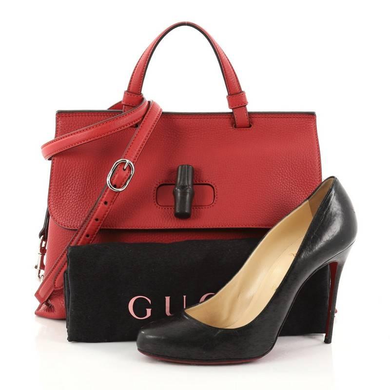 This authentic Gucci Bamboo Daily Top Handle Bag Leather Medium is perfect for everyday use. Crafted from red leather, this gorgeous bag features flat top handle, adjustable and detachable shoulder strap, side magnet detailing, flap turn-lock