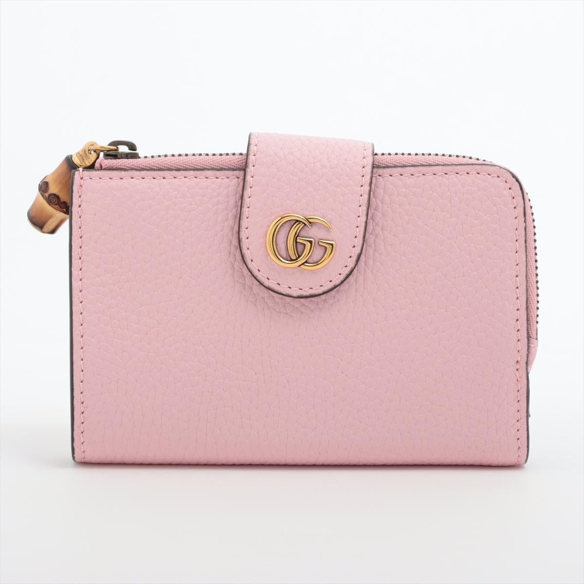 The Gucci Bamboo Double G Leather Bi-fold Wallet in Pink is a luxurious and stylish accessory that embodies the essence of Gucci's iconic design elements. Crafted from high-quality leather, the bi-fold wallet features a signature bamboo zipper pull