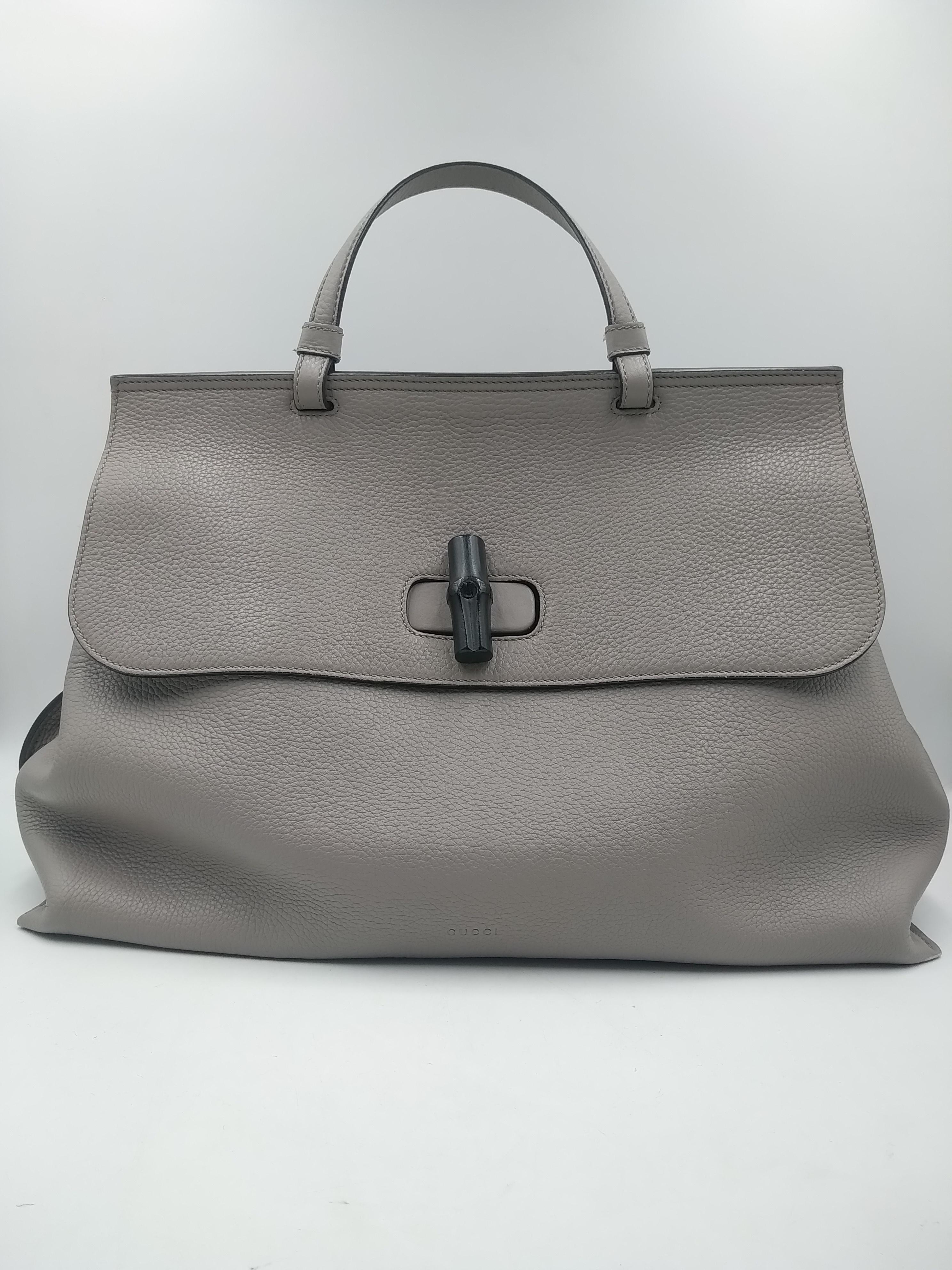 Gucci Bamboo Gray Daily Top Handle Shoulder Bag, 2015
- 100% authentic Gucci
- very soft gray grained calfskin
- opening with a dark brown bamboo turn-lock
- lined in pastel rose colored striped canvas
- one zip pocket against the back and two small