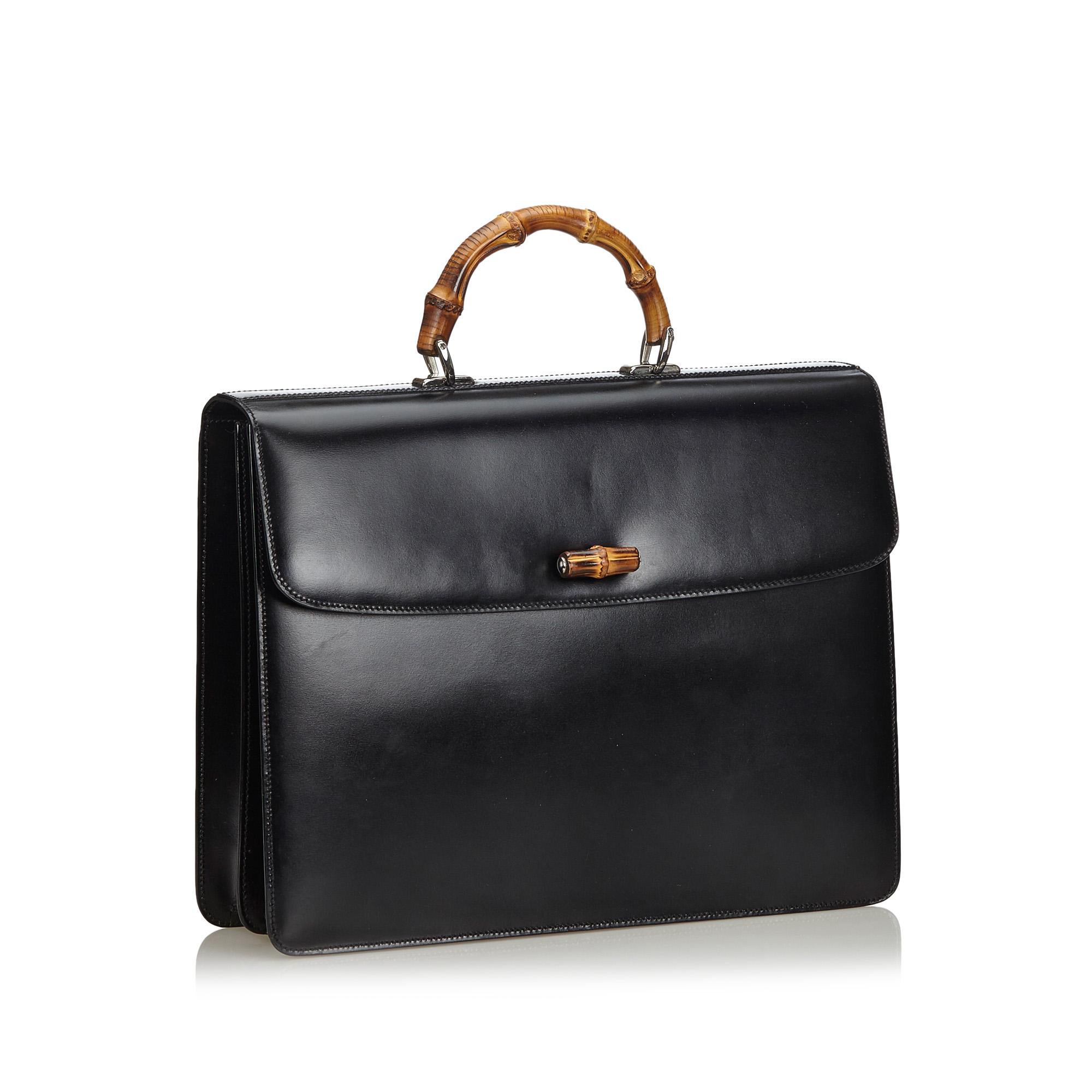 Gucci Bamboo Leather Briefcase

This briefcase features a leather body, a bamboo top handle, a front flap with a twist lock bamboo closure, interior slip compartments, and an interior zip pocket. 

Approx. Length: 10 cm. Width: 19 cm. Depth: 2 cm.