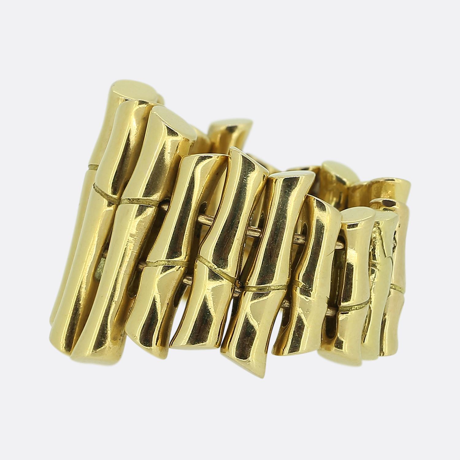 Here we have a remarkable ring from the world renowned fashion house of Gucci. This piece features a bold design, reminiscent of bamboo stalks, crafted from a rich 18ct yellow gold. The ring's structure is composed of multiple vertical segments,