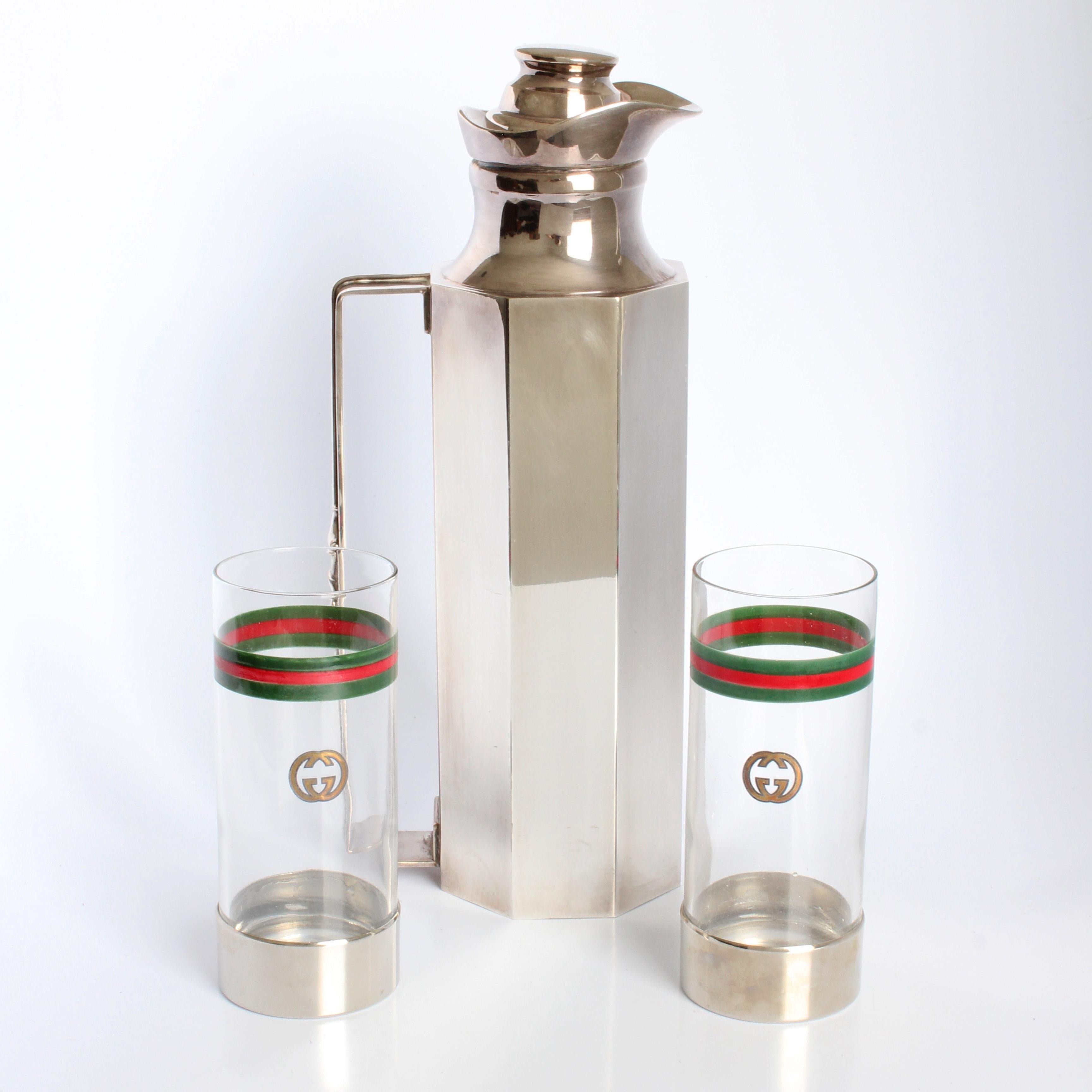 Entertain in style! Preowned, authentic, vintage Gucci barware GG logo cocktail glasses and silver plate decanter, circa the 70s. Set includes 2 highball glasses, made of crystal with silver plate base and 1 silver plate decanter with lid.