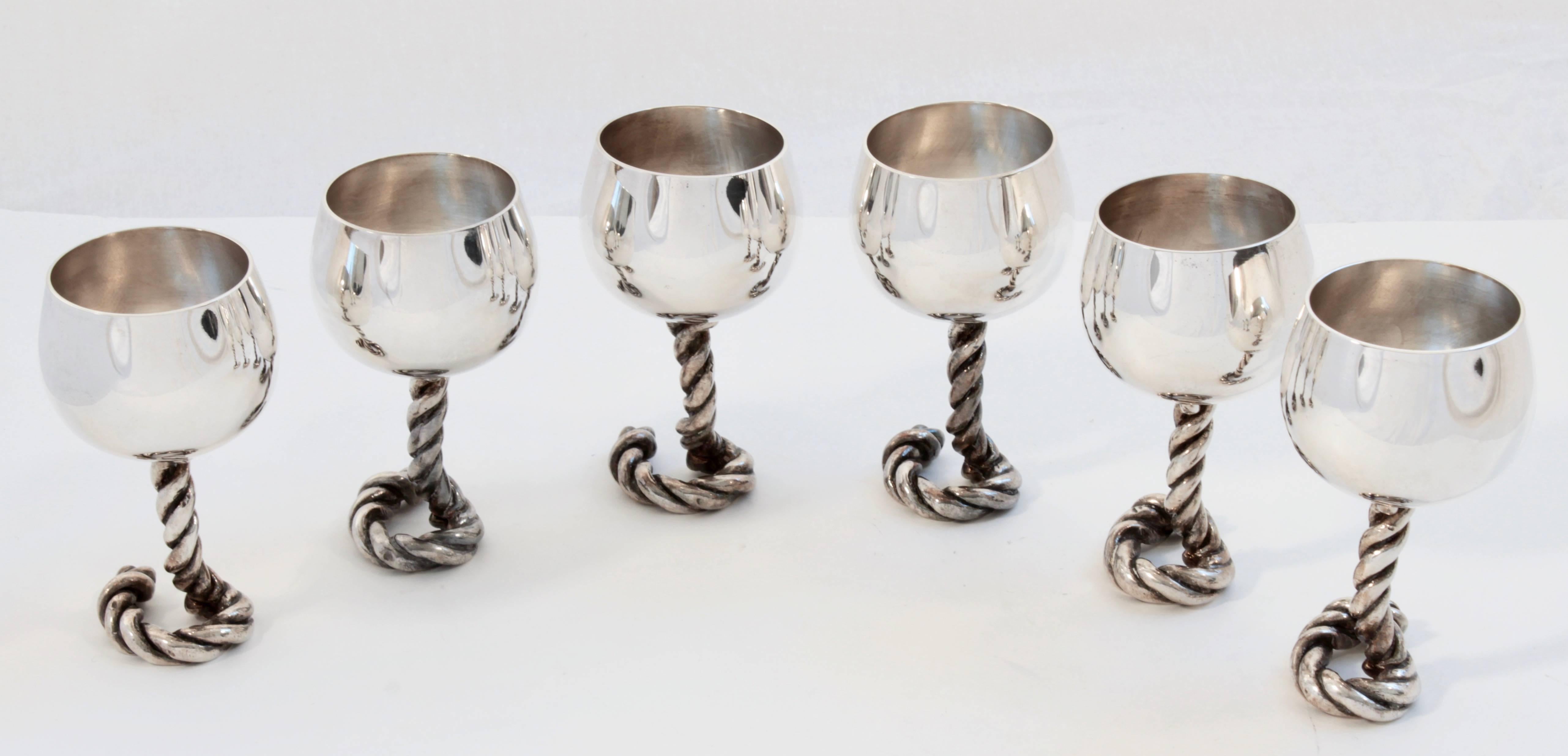 This set of 6 silver goblets was made by Gucci, most likely in the early 1970s.  Each goblet features a chunky equestrian rope stem and measures appx 5.25in H x 3in D.  Perfect for entertaining or for the barware enthusiast.  All in good condition