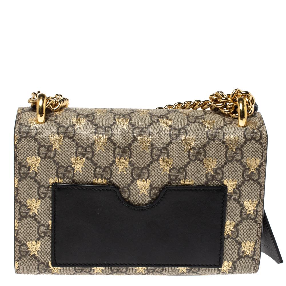 Swing this gorgeous bag and fetch endless compliments. This Gucci creation has been beautifully crafted from black-beige GG Supreme canvas and leather with bee motifs all over and a flap that carries a signature padlock. The insides are lined with