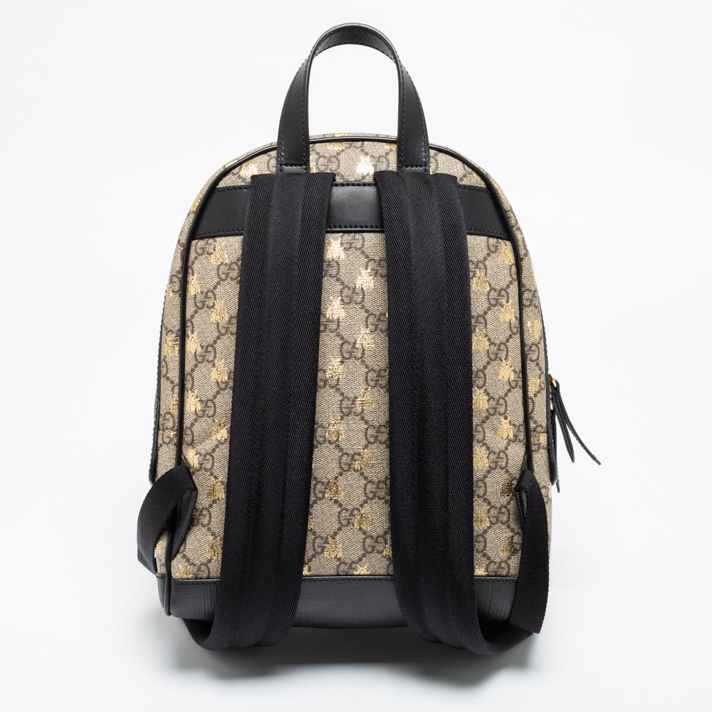 Let your trips be more joyous and stylish with this Bees backpack from Gucci. Made using black-beige GG Supreme canvas and leather on the exterior, this backpack endorses the immense skill and creativity that Gucci puts into its pieces. It is