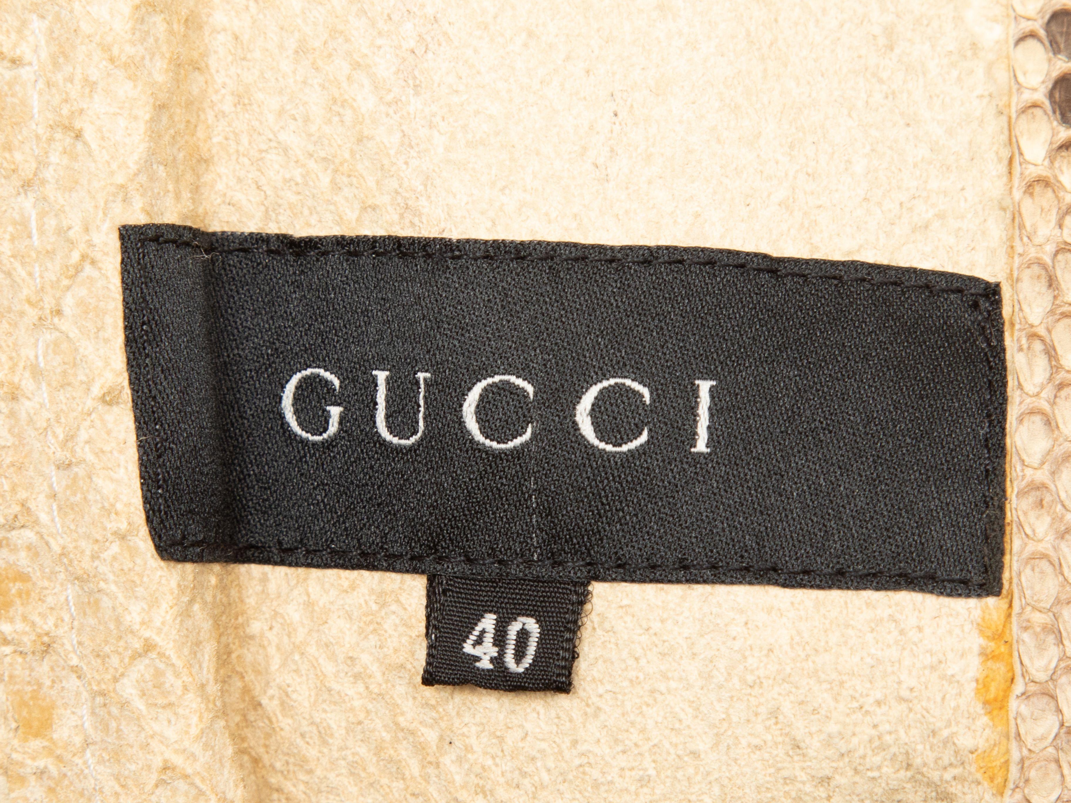 Product Details: Vintage beige and black python skin bomber jacket by Gucci. Stand collar. Dual hip pockets. Zip closure at front. 36