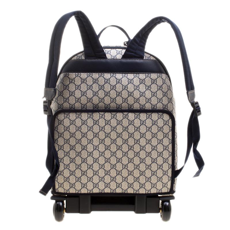 Make your travel more joyous and fun filled with this Gucci backpack. Made from GG Supreme canvas, this two-wheeled trolley backpack comes with adjustable shoulder straps and an exterior pocket secured by a zipper. It has a spacious nylon lined