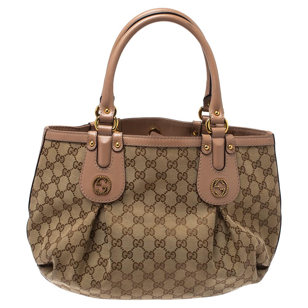 It’s impossible not to fall in love with this Gucci Scarlett tote, which has been crafted with GG canvas and leather. The pink bag features double handles, GG logo, and stud detailing in gold-tone. It has a roomy fabric-lined interior with one