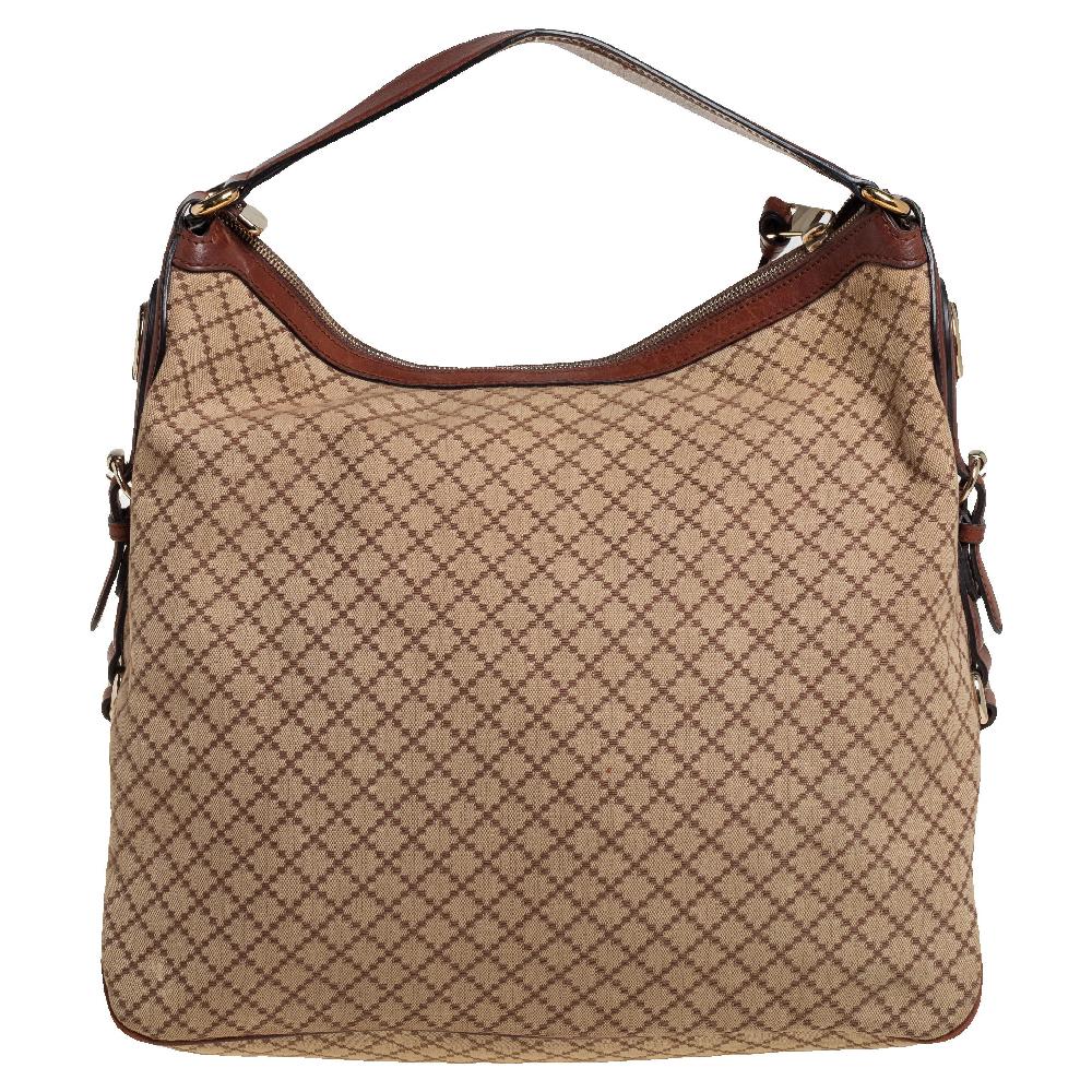 This chic and classy hobo is from Gucci. The bag is made from Diamante canvas and enhanced with leather and the iconic Double G motif on the side. The bag features a single handle and a top zip closure that opens to a spacious canvas interior.