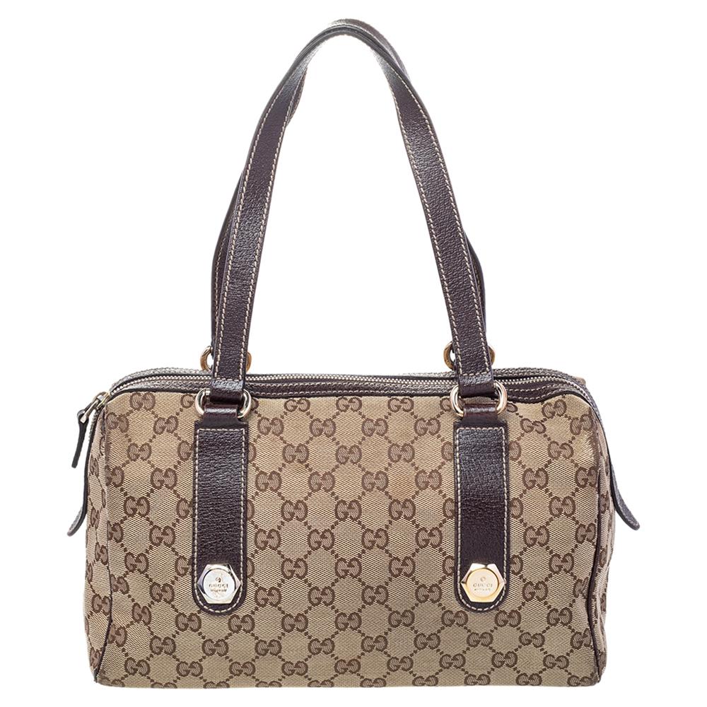 This Charmy Boston bag from Gucci is truly charming and comes finely crafted from the signature GG canvas and leather. It is styled with logo-engraved studded straps on the front and back and flaunts dual handles and a top zip closure that opens to