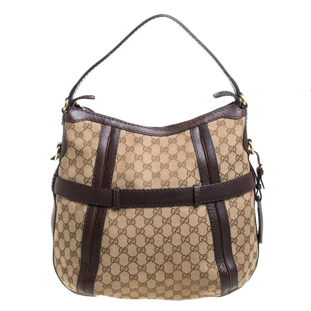 This chic and classy hobo is from Gucci. The bag is made from GG canvas and enhanced with leather and the iconic Double G motif on the front. The bag features a single handle, a removable shoulder strap, and a top zip closure that opens to a