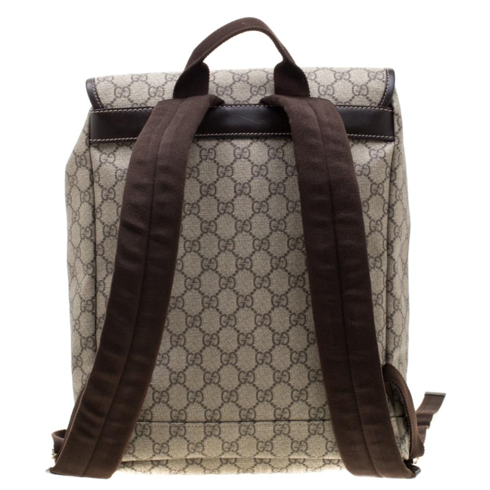 Crafted with the signature GG canvas and leather, this backpack offers a premium look. This creation of Gucci has a flaptop that opens to a wide fabric interior housing a zip pocket and wide space for more than just your essentials. With a front zip