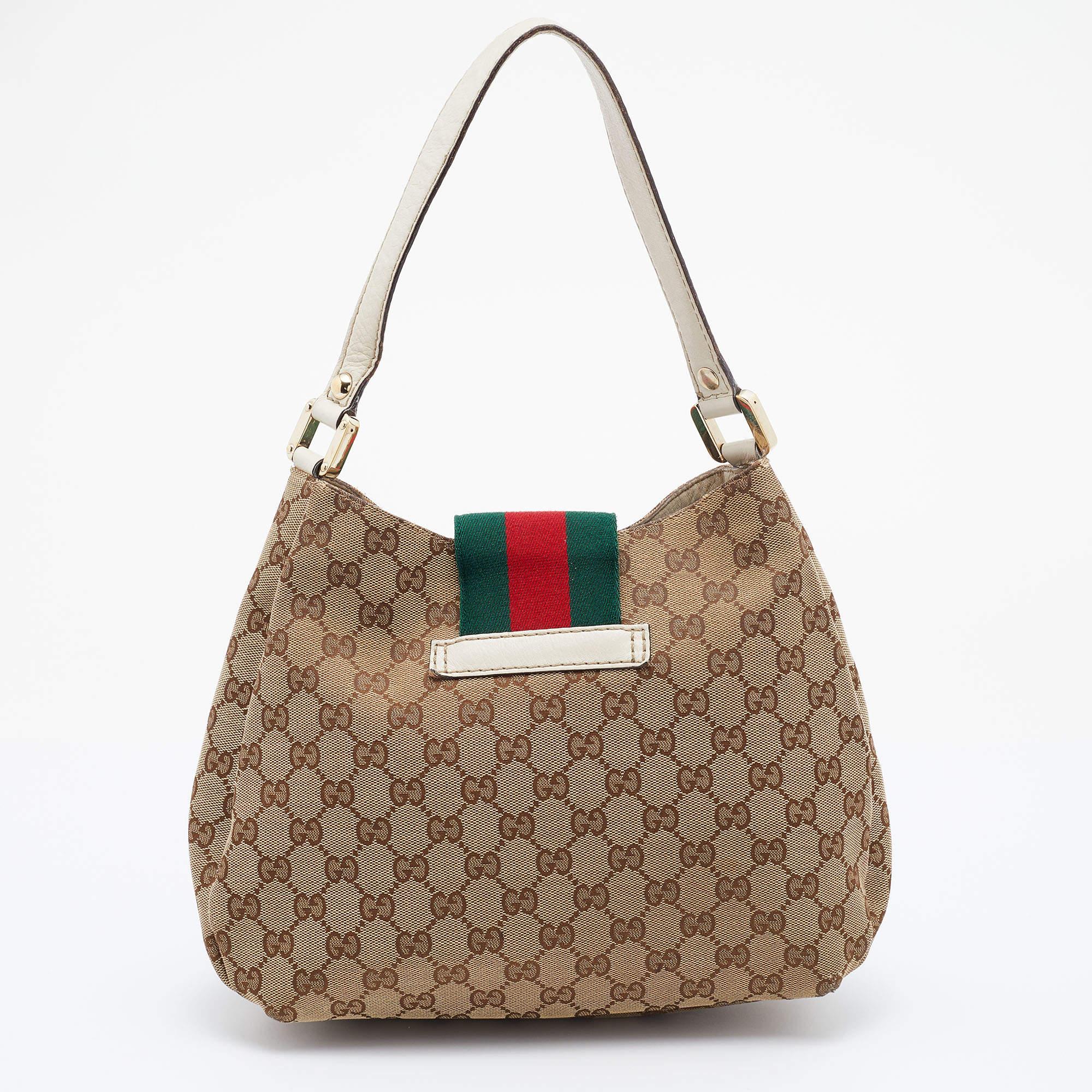 Crafted from GG canvas and leather in Italy, this gorgeous bag from Gucci is a design that has never gone out of style. It has a Web strap detail and a spacious fabric interior. Held by a single handle, this bag is ideal for daily use.

Includes: