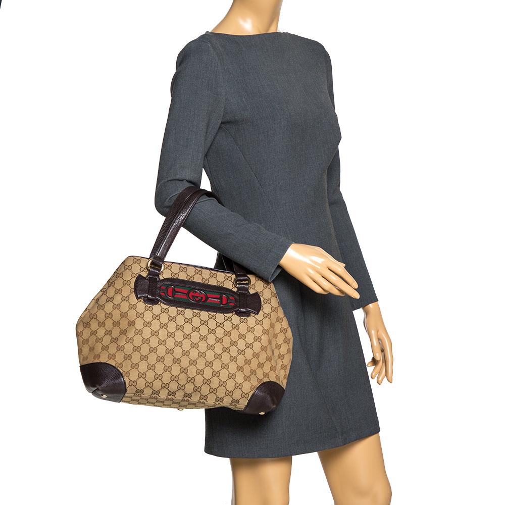 This Gucci creation will fetch you admiring glances as this tote is stylish and handy. The bag has been crafted from GG canvas and leather and is equipped with dual handles and the signature detailing on the front. The tote comes with a spacious