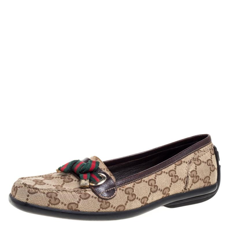 Purposely created to exude style and provide comfort wherever you go, this pair of loafers by Gucci is absolutely worth the buy! They've been crafted from the signature GG canvas and leather, styled with Web bows on the vamps, and finished with