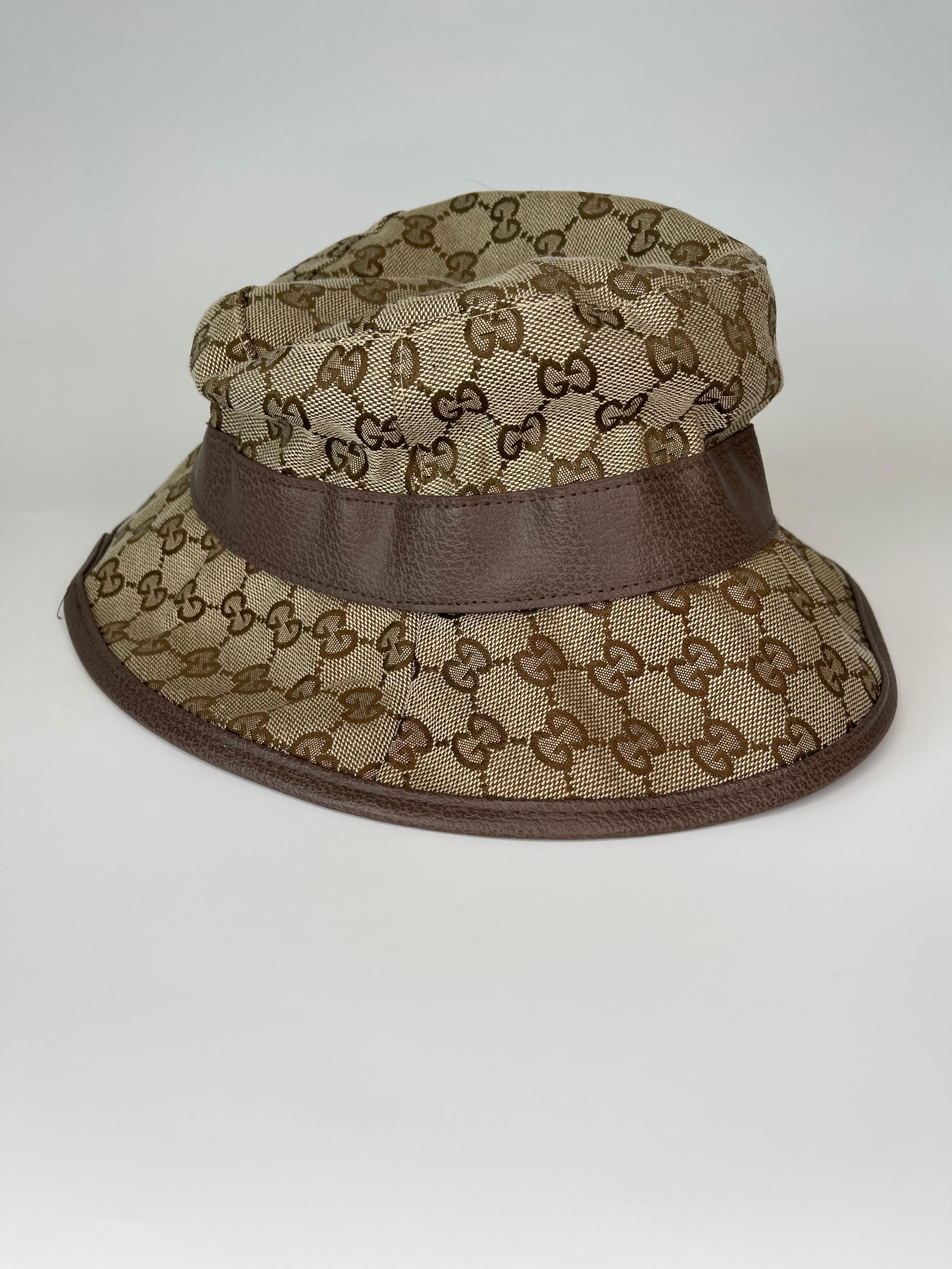 Cotton-blend canvas fedora in beige featuring monogram logo pattern, grained faux-leather trim in brown throughout.  Features GG logo in gold hardware as well. Very good condition. 

COLOR: Beige monogram, brown 
MATERIAL: Canvas, leather,