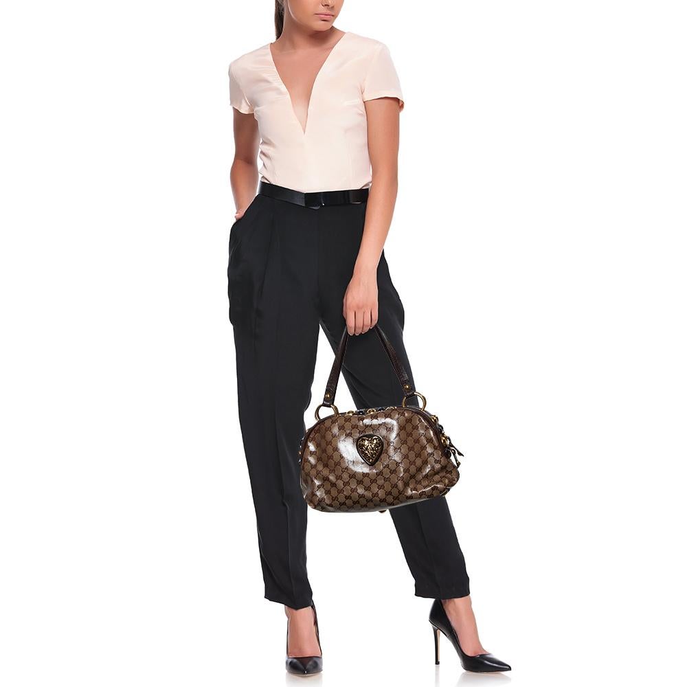 This Gucci Babouska creation might just become the most loved classic bag in your closet. Crafted from GG crystal canvas, it has gold-tone stud detailing and the signature crest detail on the front. The bag is equipped with two handles and a