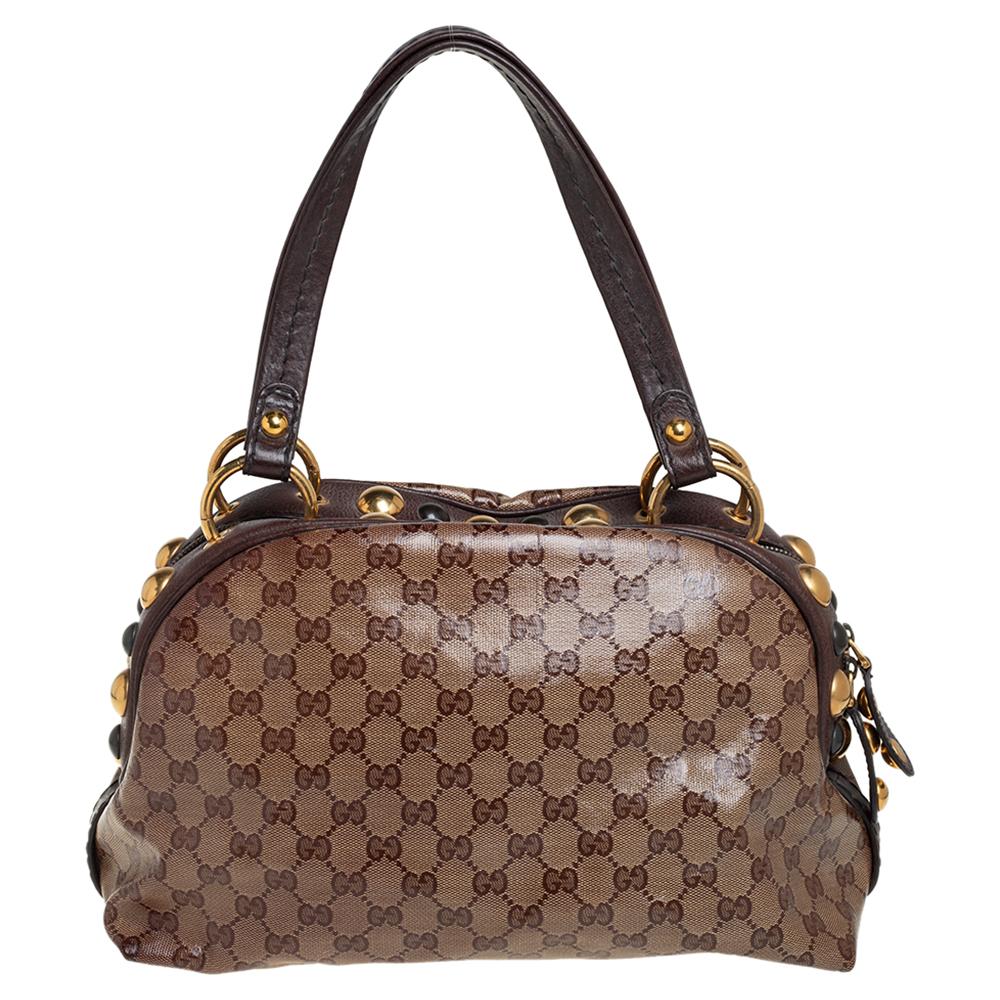 This Gucci Babouska creation might just become the most loved classic bag in your closet. Crafted from GG crystal canvas, it has gold-tone stud detailing and the signature crest detail on the front. The bag is equipped with two handles and a